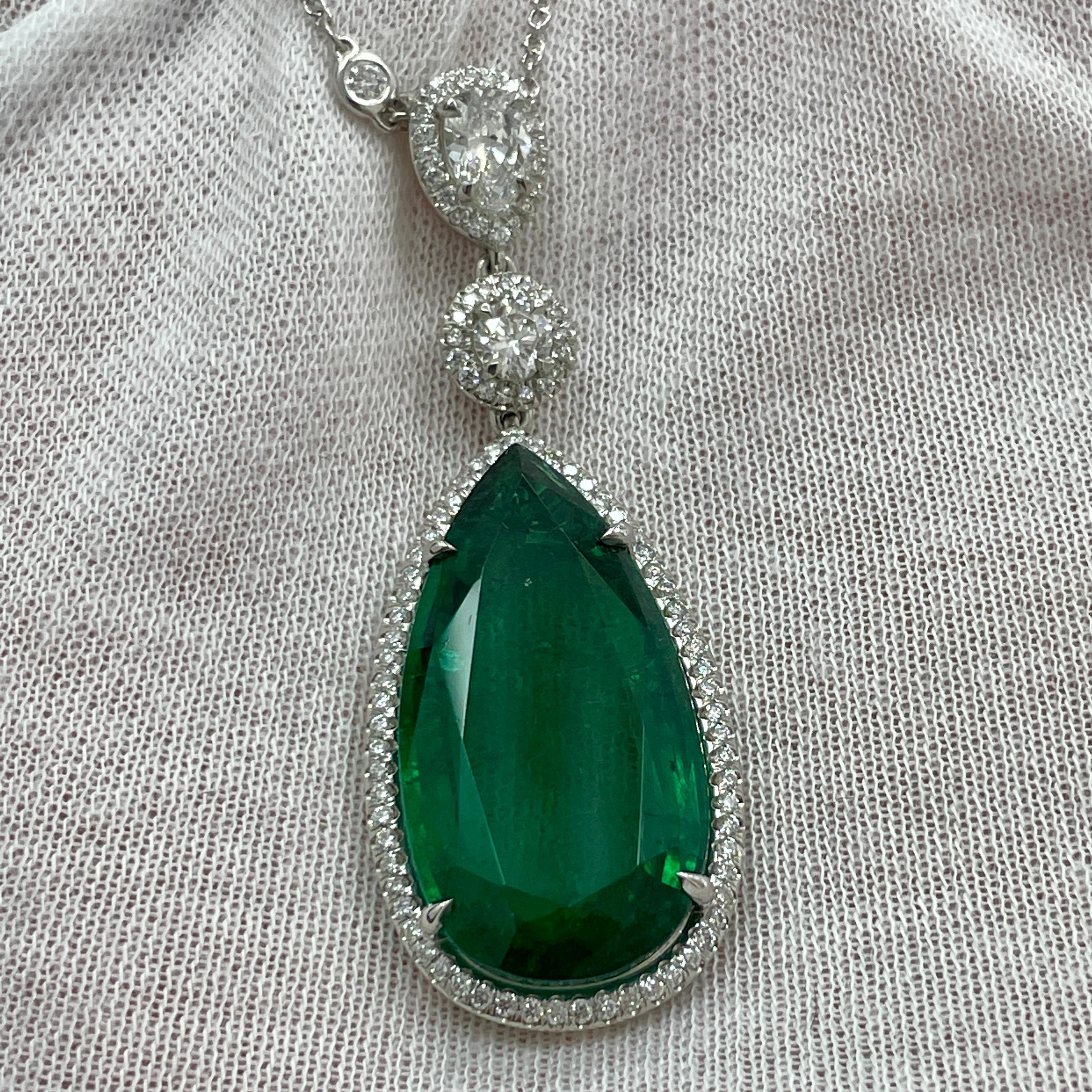 A simple yet elegant pear shape emerald in a platinum pendant with brilliant GH VS white diamonds on a 14k white gold diamonds by the yard chain