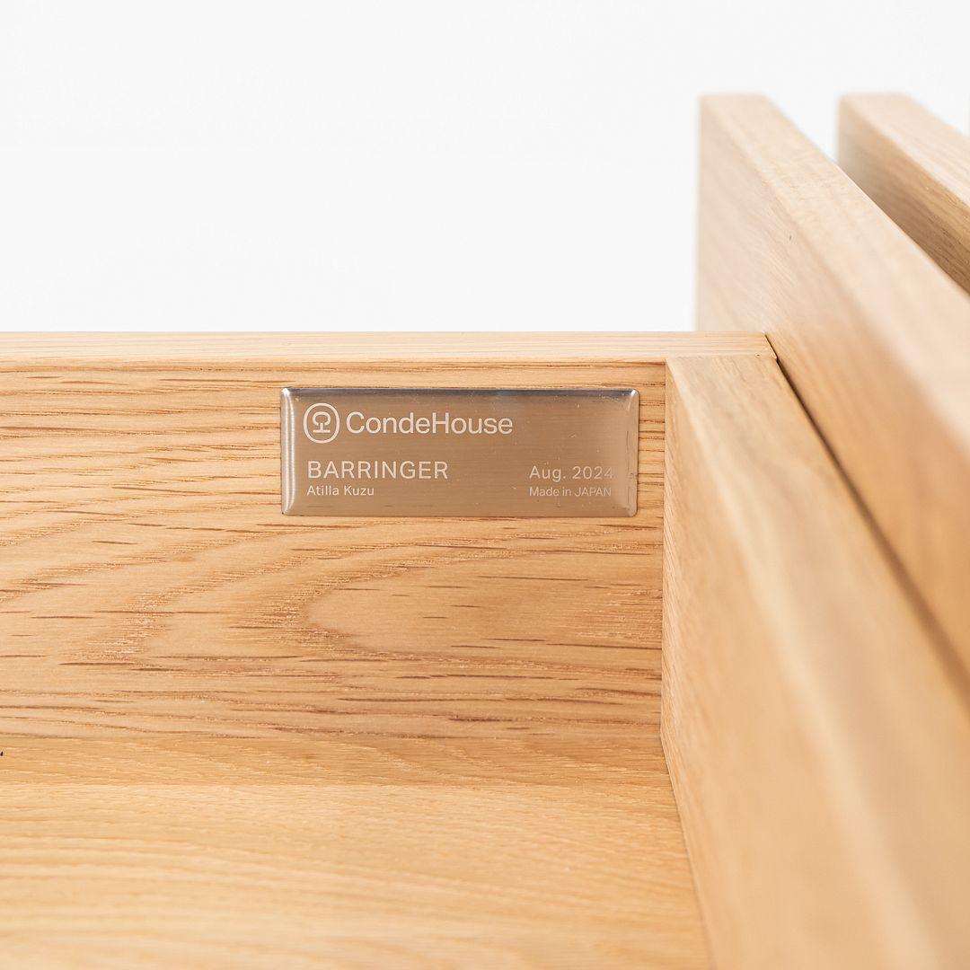 This is a Barringer Slide Coffee Table, originally designed by Atilla Kuzu for CondeHouse in 2002. This particular example was produced in Japan in 2024. The table is comprised of Japanese Oak, and the design allows for all four corners to slide out
