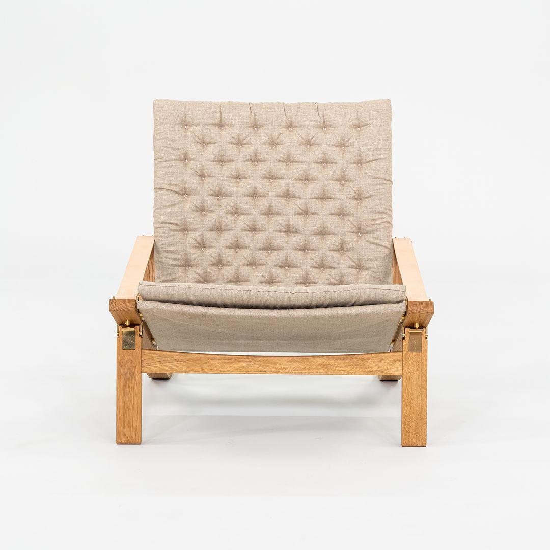 This is a FK11 folding adjustable lounge chair, originally designed by Preben Fabricius and Jorgen Kastholm in 1963. This particular example was produced by Carl Hansen & Son in Denmark C. 2024. The chair is comprised of solid wood, steel, foam,