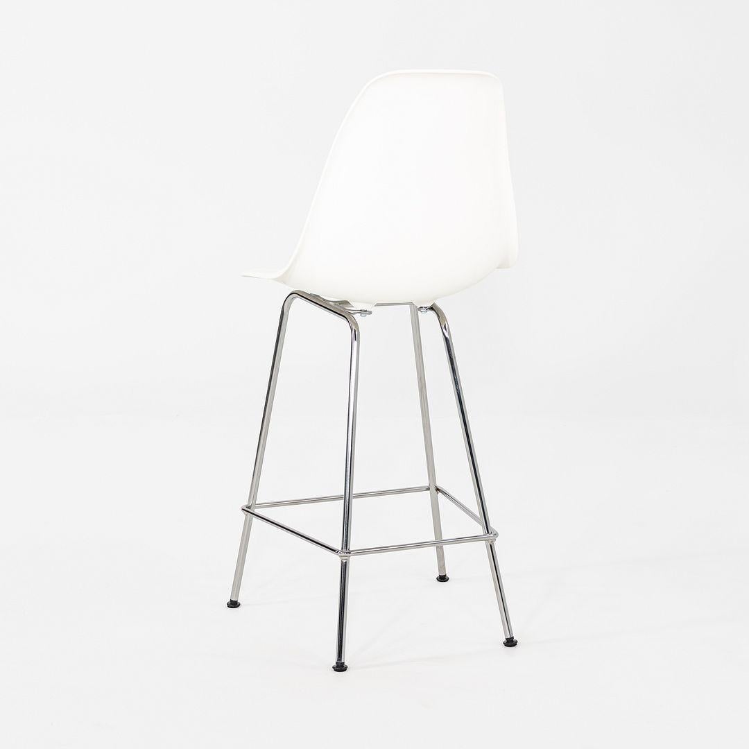 This is a pair of Eames Plastic Counter stools, which were developed by Herman Miller in 2015. These particular examples were produced in 2024. The stools are comprised of chrome bases with a plastic shell seat in white. 

The listed price includes