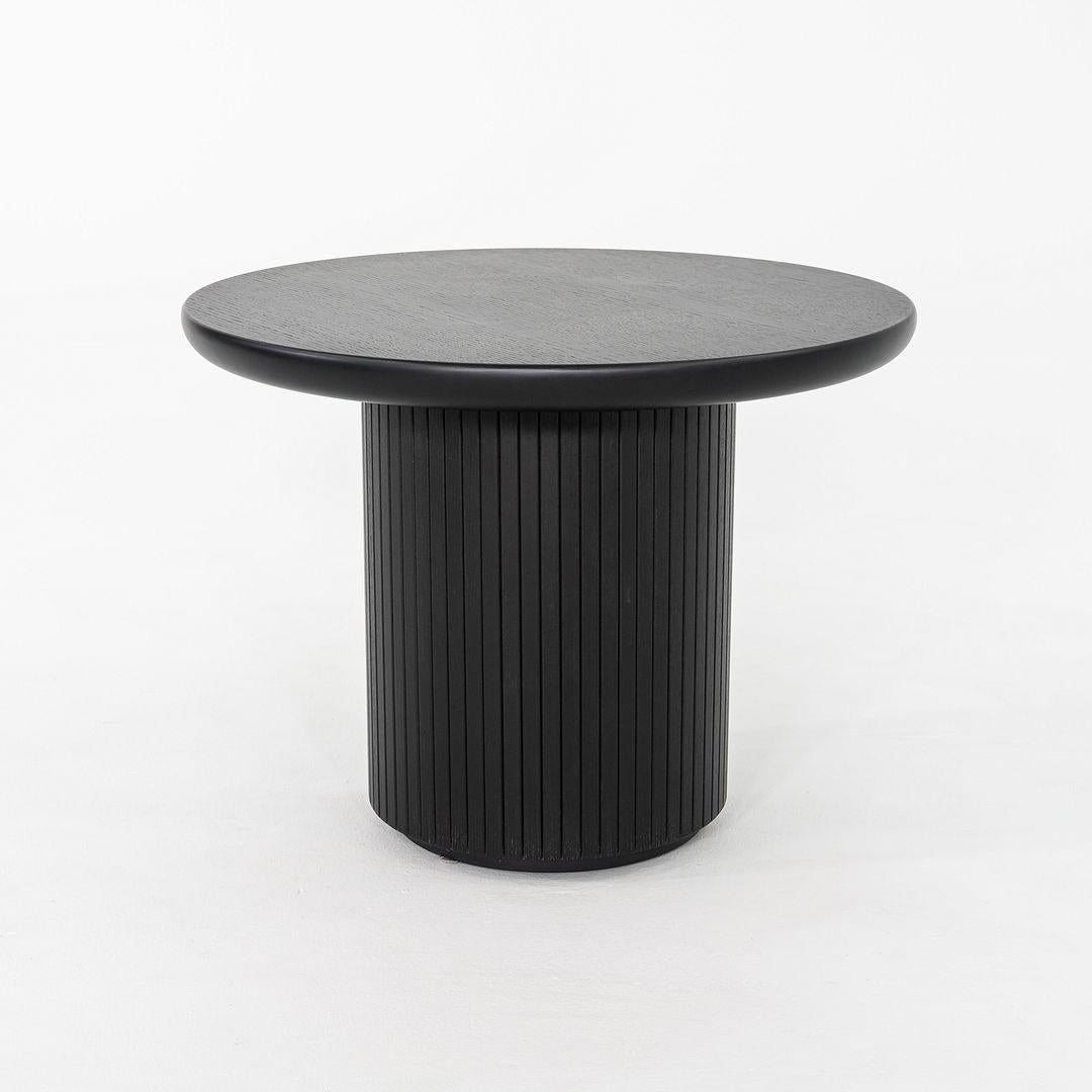 This is a pair of Moon side / lounge tables, originally designed by Space Copenhagen for GUBI in 2015. These particular examples were produced in Denmark in 2024. The tables are comprised entirely of black stained veneer oak lacquered. The listed