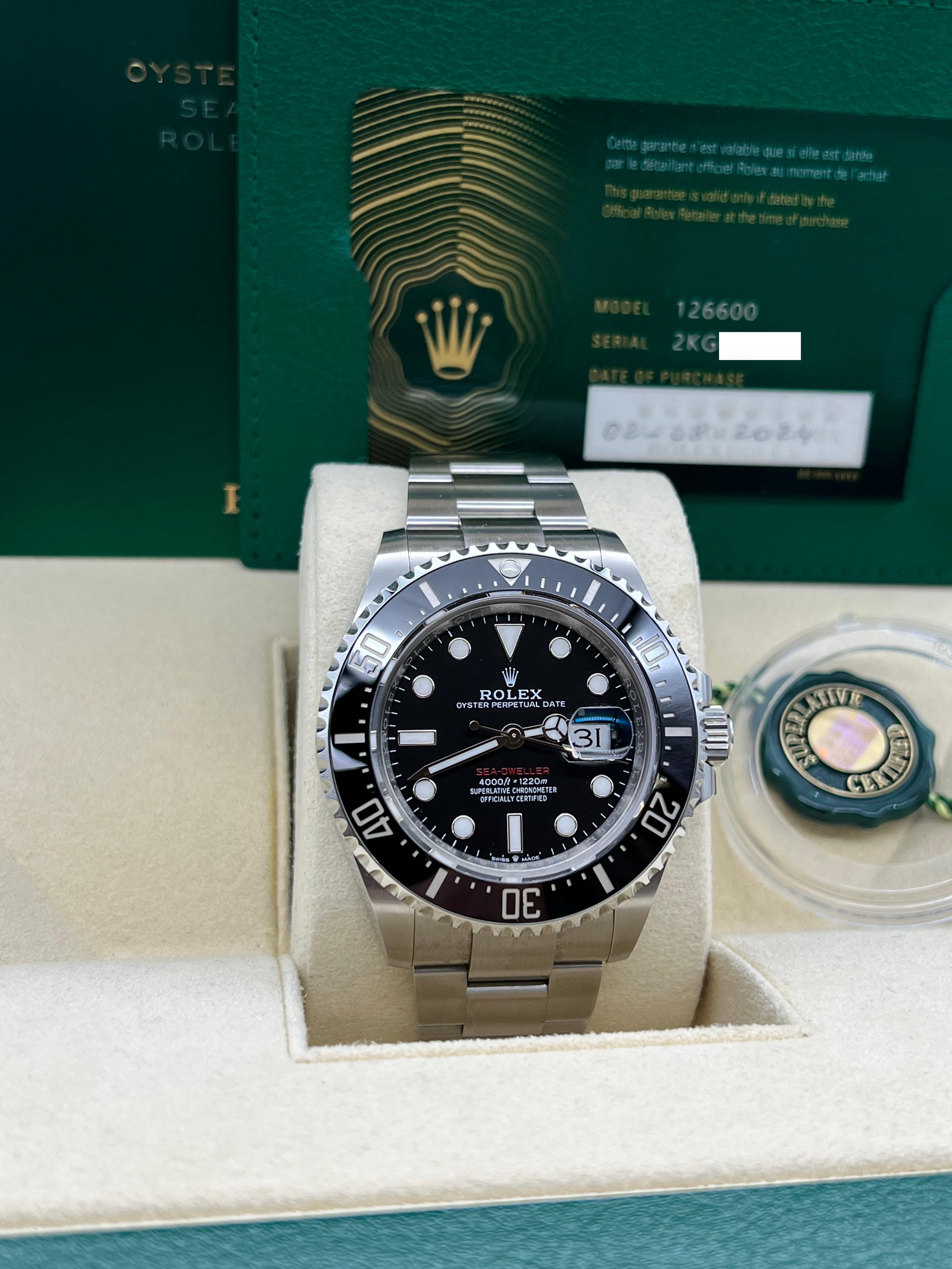 Style Number: 126600
Serial: 2KG98***
Year: 2024
Model: Rolex Red Sea Dweller
Case Material: Stainless Steel 
Band: Stainless Steel 
Bezel: Black Ceramic 
Dial: Black With Red Letters 
Face: Sapphire Crystal 
Case Size: 43mm 
Includes: 
-Rolex Box &