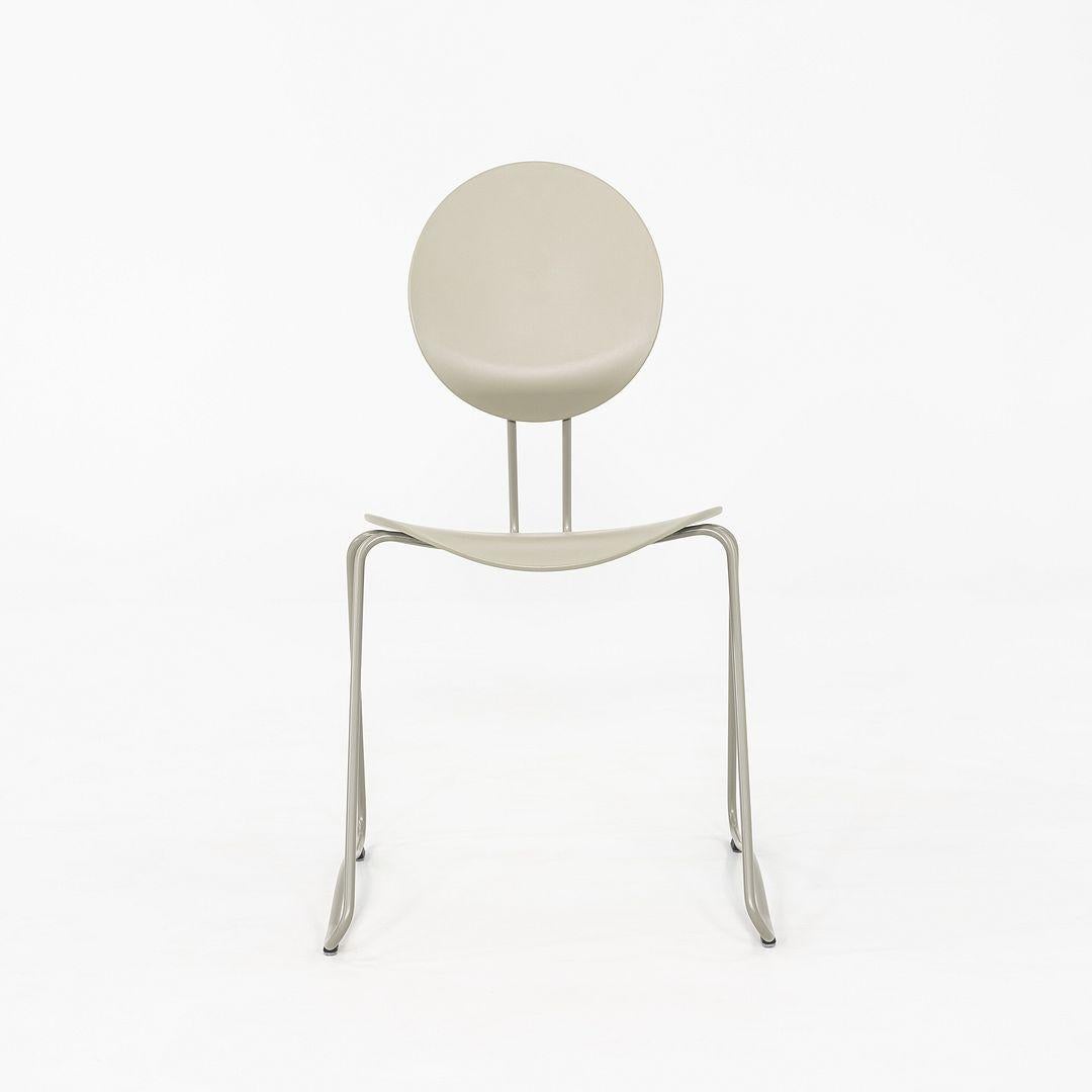 This is a set of four Flex Chairs, originally designed by Verner Panton for Verpan in 1960. These particular examples were produced in Denmark in 2024. The chairs feature a tonal grey-on-grey finish, with molded seats and backrests mounted on