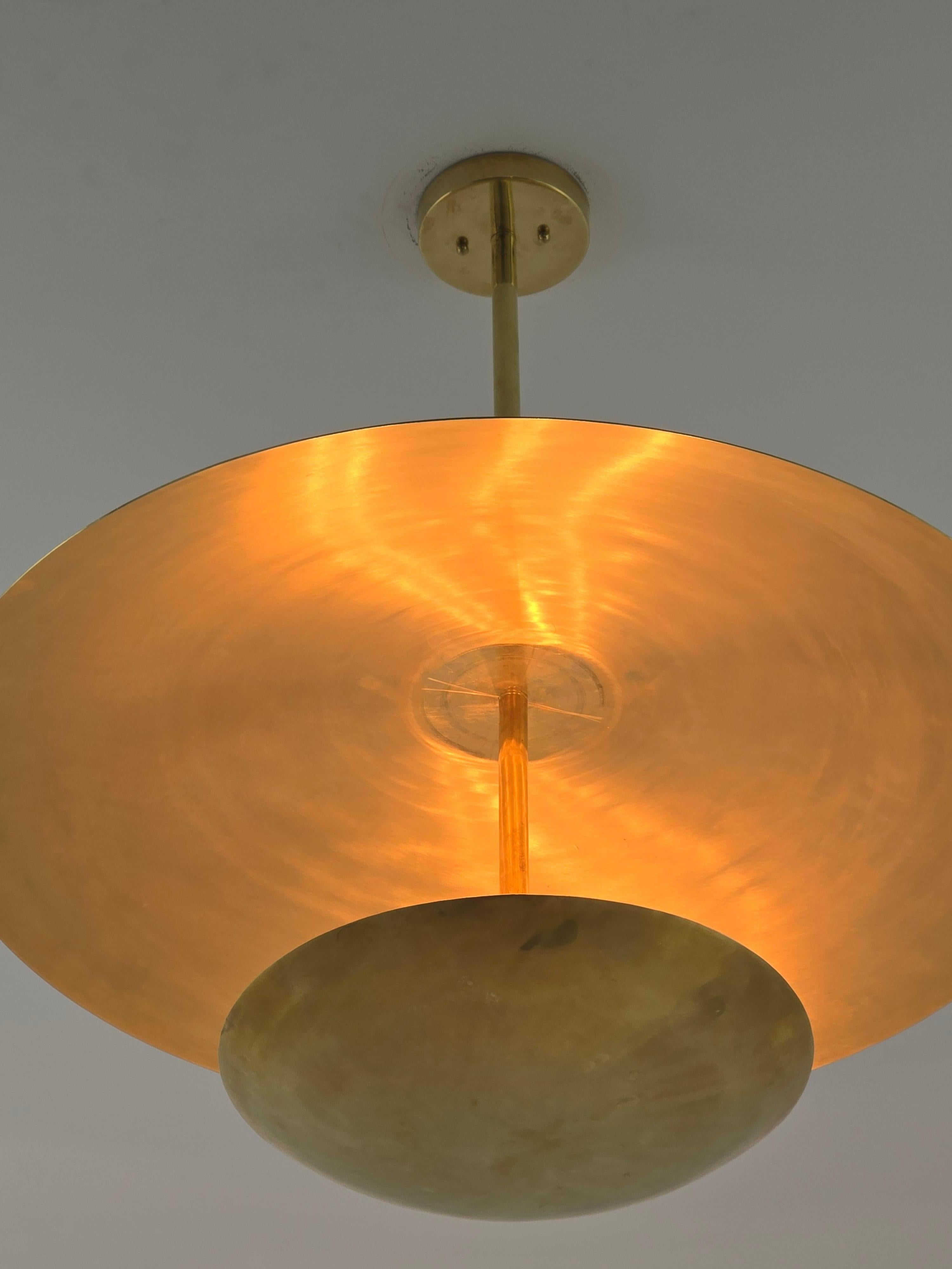 Concave and convex Brass  pendant Uplighter with 5 lights  . Disc are hand spun with prime quality brass . 

Solid sturdy hardware and construction .

Diameter 30”

Height: 25