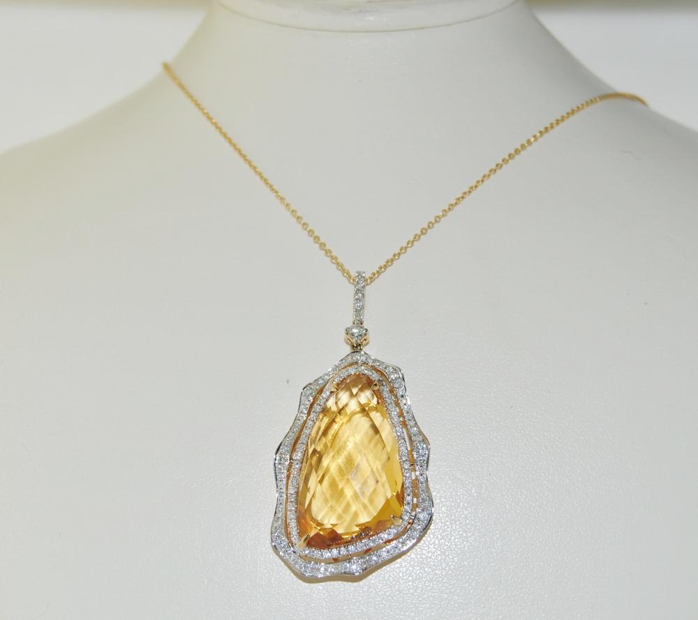 Pendant necklace featuring 20.26 carat checkerboard surface Citrine surrounded by 0.79 carat brilliant white diamonds.  This pendant is mounted in 14K yellow gold.  Length 1.75 inches, width 1 inch.  Includes 18 inches chain.