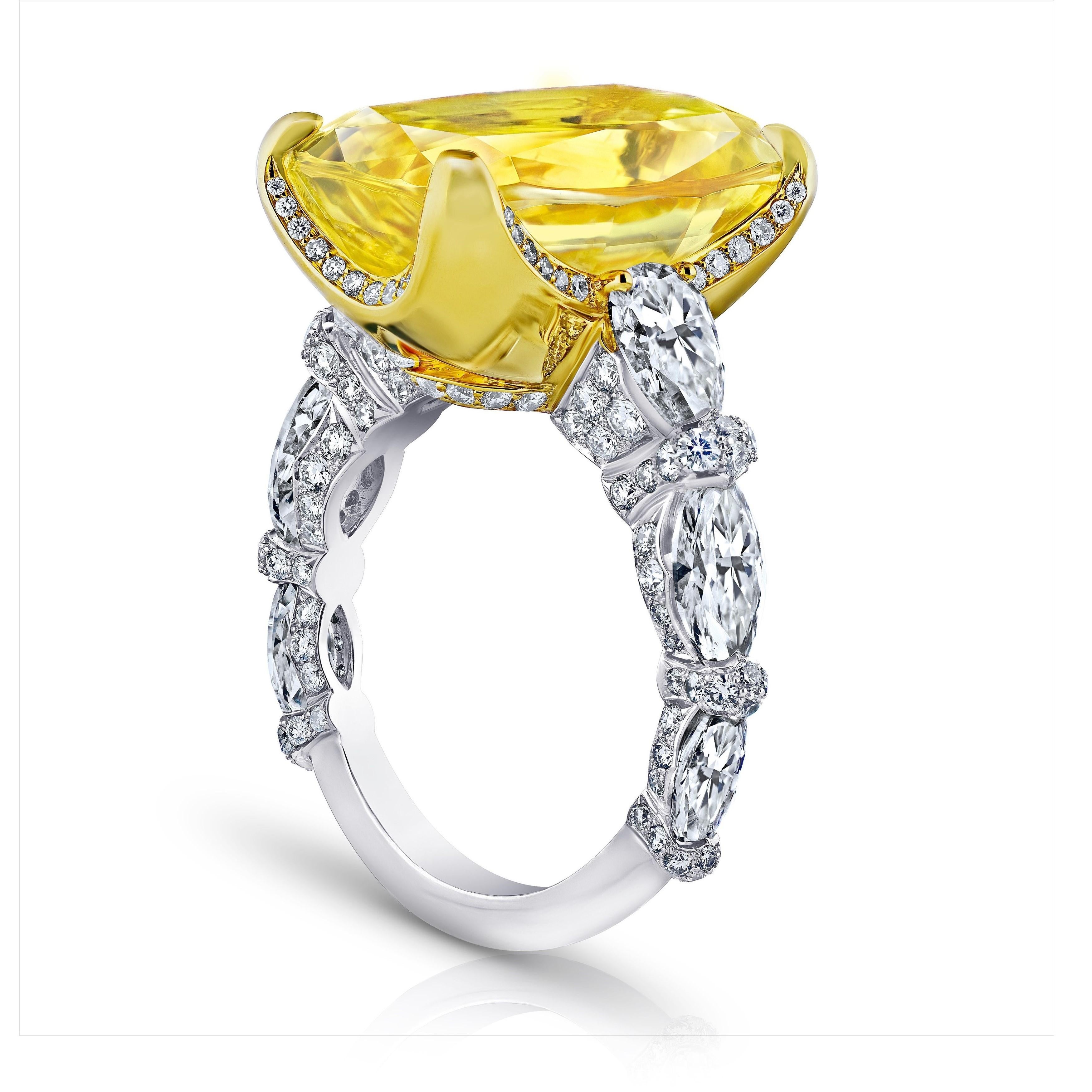 20.26 carat yellow cushion sapphire with pear shape, marquise and brilliant round diamonds 3.63 carats set in a platinum with 18k yellow gold ring. This ring has won a first place award at the AGTA jewelry design competition. It is a true work of