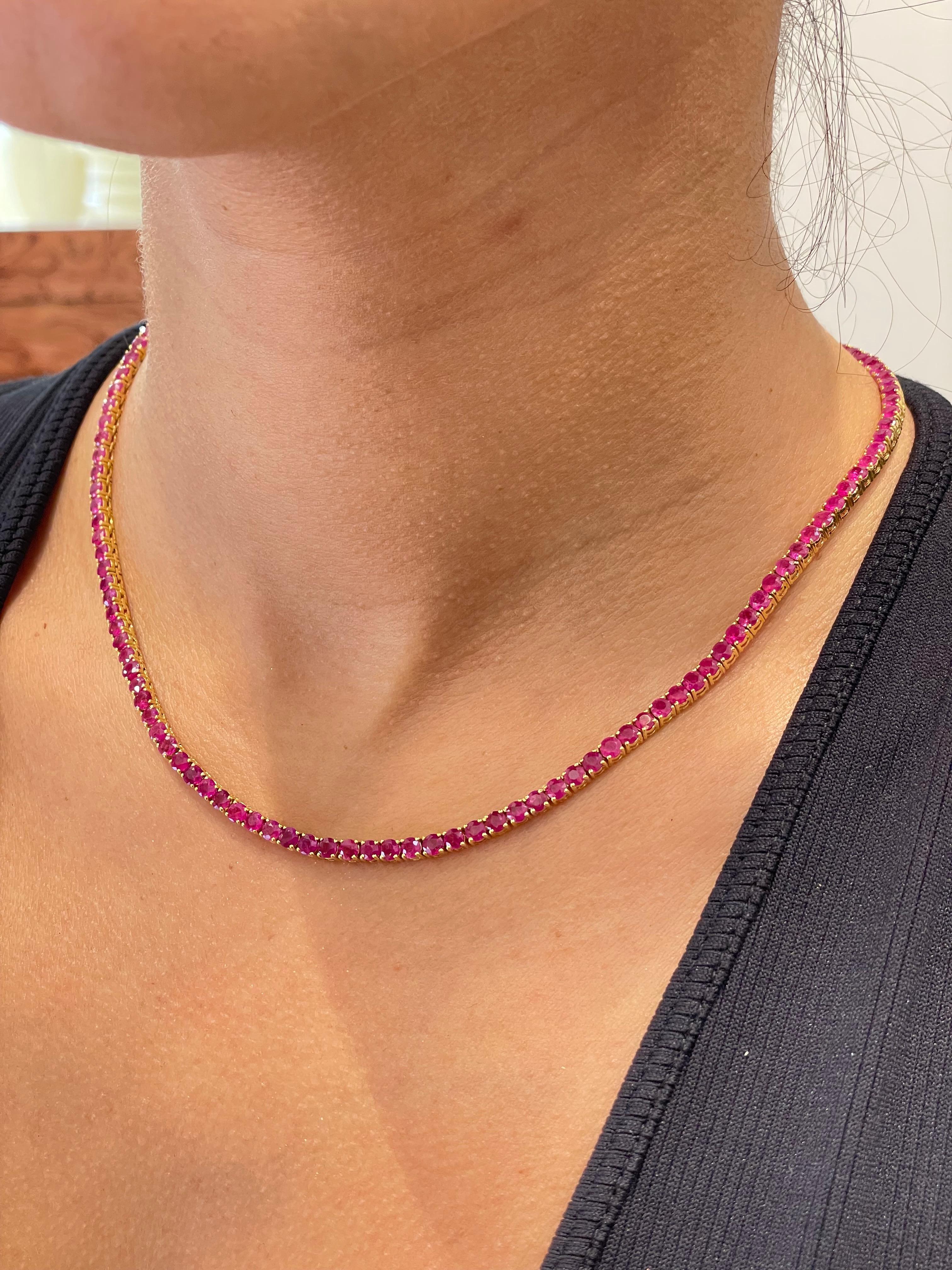 An impressive classic Tennis
Necklace a line that features a substantial total Ruby weight of 20.28 Carats in beautifully graduated Round Cut gems.
each stone has a four-claw setting with open gallery and set in 18 Karat yellow Gold, essential for a