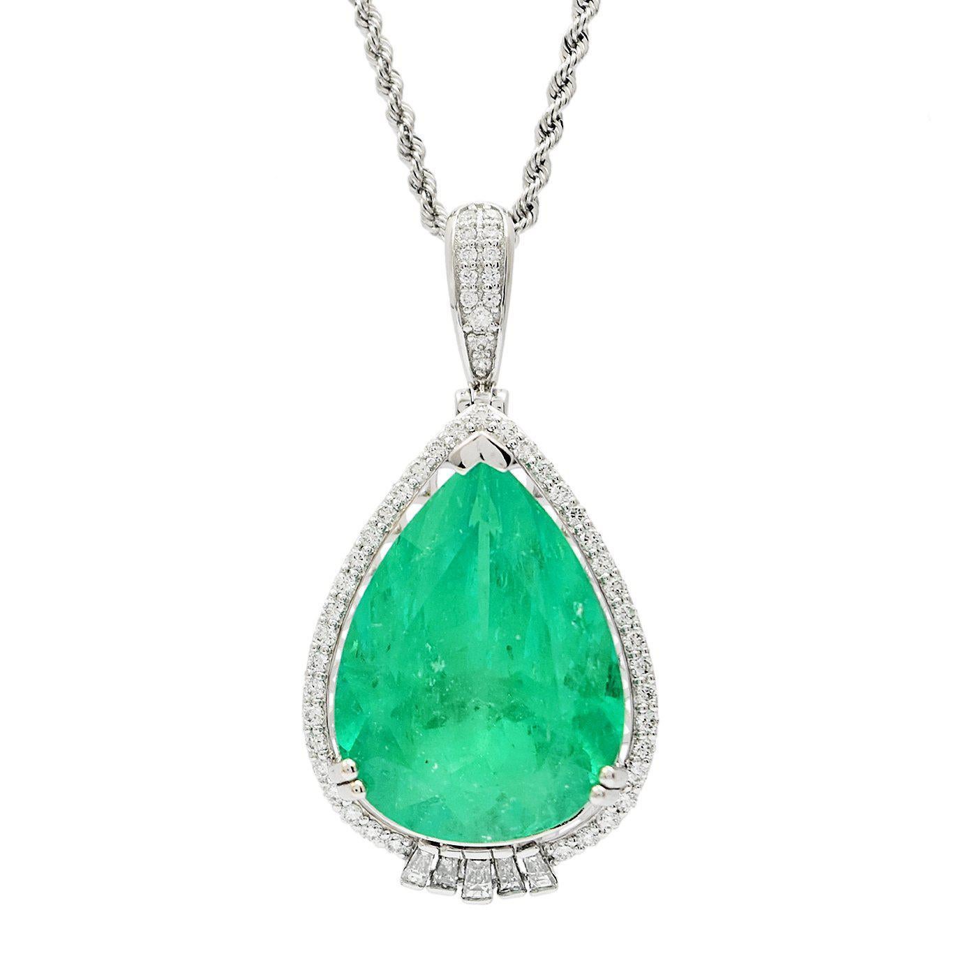 One electronically tested platinum ladies cast & assembled emerald and diamond pendant with chain. The pendant features an emerald set within an inner platinum basket and an outer stylized diamond bezel, completed by a hinged diamond set bail. The