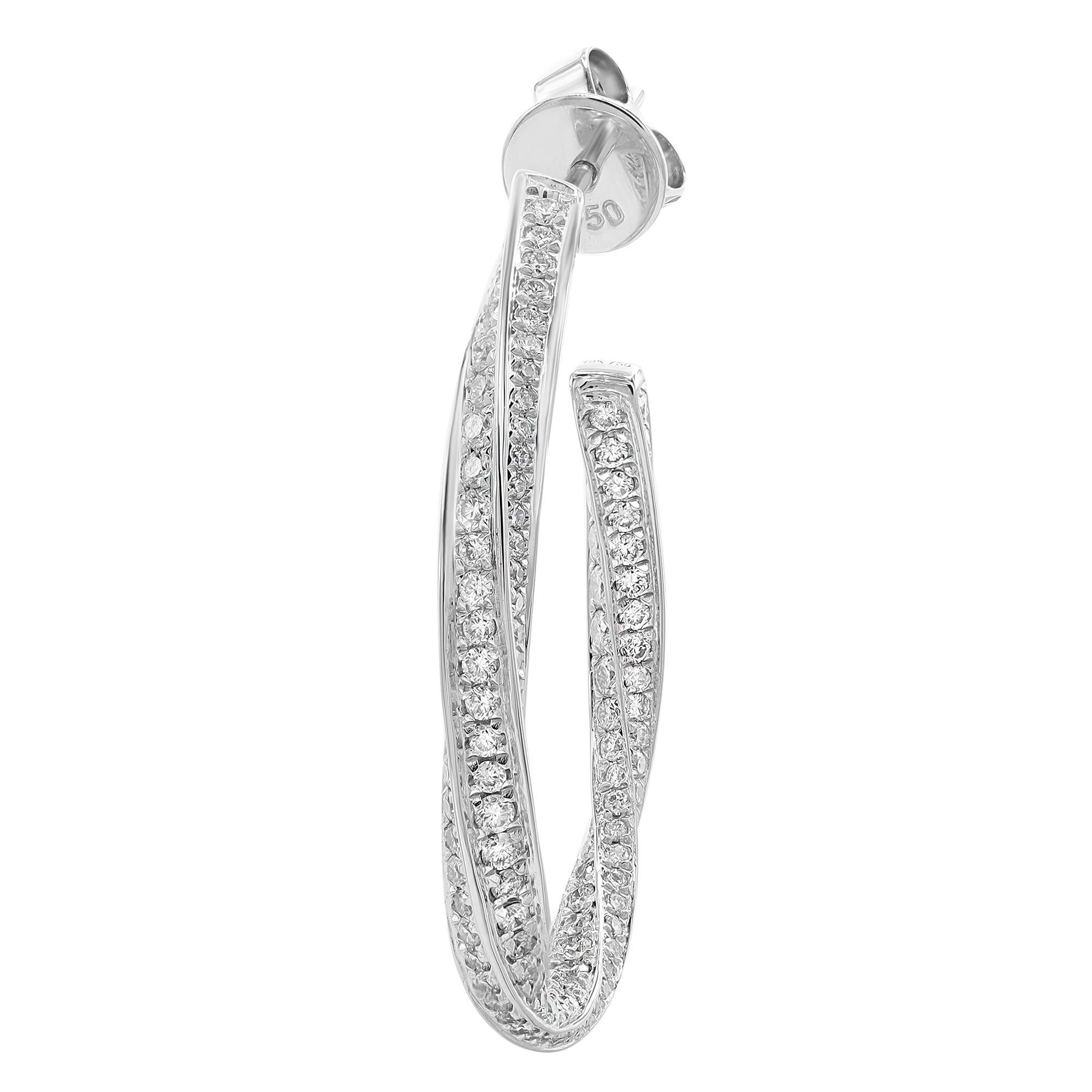Dainty and dazzling diamond hoop earrings, perfect for a standout look. These earrings are crafted in fine high polished 18K white gold and pave set with bright white round cut diamonds weighing 2.02 carats. Diamond quality: color G-H and clarity