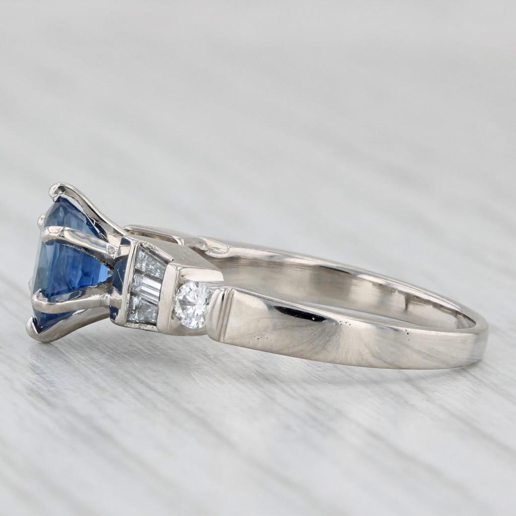 Gemstone Information:
- Natural Sapphire -
Carats - 1.35ct 
Cut - Oval 
Color - Dark Blue
Treatment - Heated

- Natural Diamonds -
Total Carats - 0.37ctw
Cut - Round Brilliant 0.12ctw, Baguette 0.25ctw
Color - G - H
Clarity - VS2 - SI1

Metal: