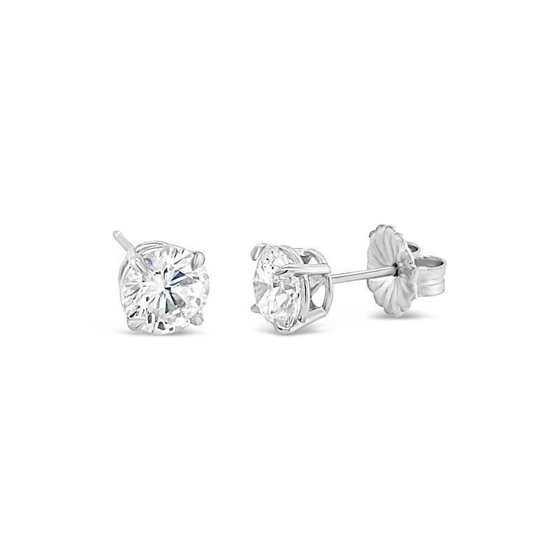 Classic diamond stud earrings of H VS2 quality weighing a total of 2.02 carats set in 18 karat white gold 4 prong basket settings. Friction post and back. 
GIA Report: 5201825458 & 2146098227 (6.48 - 6.49 x 3.91 mm)