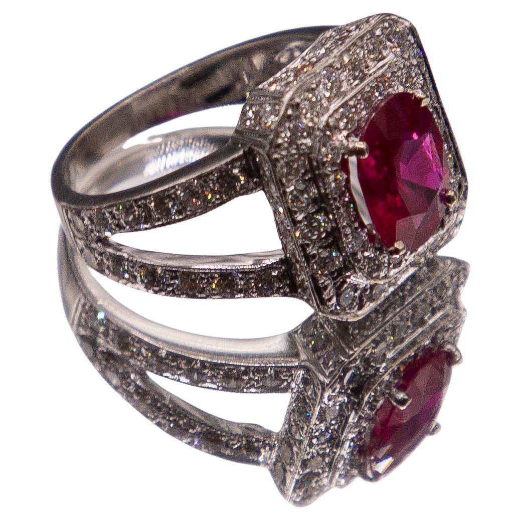 A one-of-a-kind 14k white gold ring features an American Gemological Laboratories Certified 2.03 carat oval Burma Red of extraordinary color, transparency and clarity. The near Flawless, top- collection color ruby, referred to traditionally as 