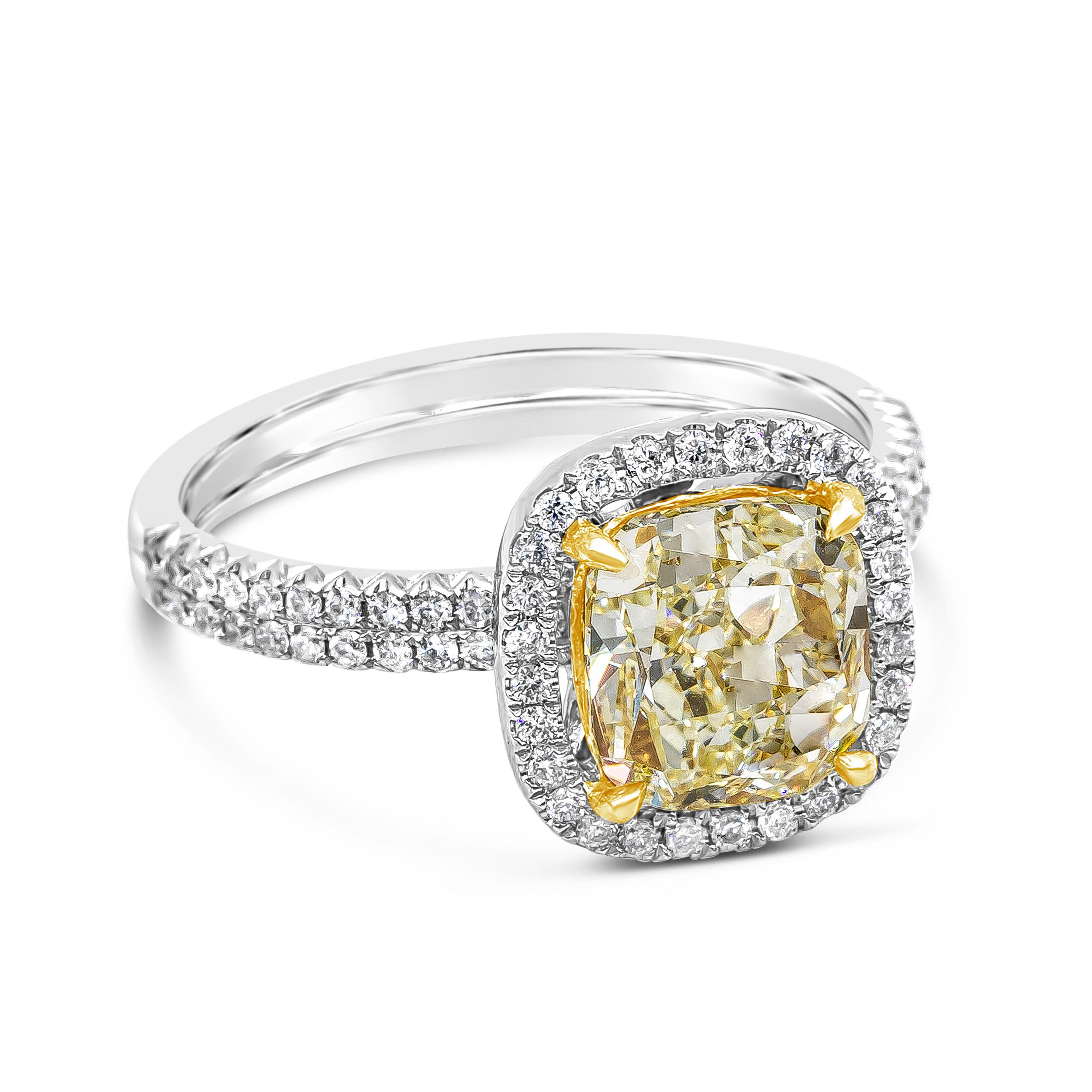 Showcasing a 2.03 carats cushion cut yellow diamond center, set in a floating halo of round brilliant diamonds, four prong made in 18K yellow gold. Shank is double-row diamond encrusted in half eternity setting. Made in 18 karat white gold. Accent