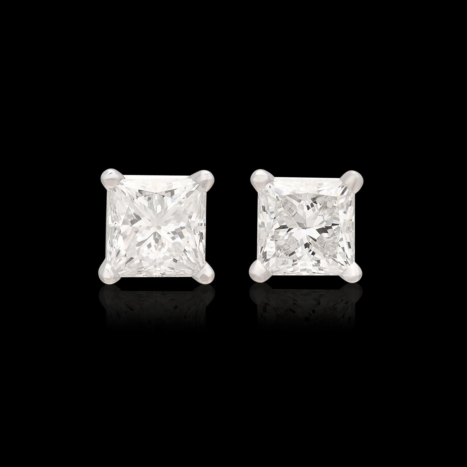 Perhaps the perfect pair of diamond stud earrings. This 18 karat white gold pair features near perfectly matched 1.01 carat and 1.02 carat GIA graded princess cut diamonds (E-G/VS2). Both diamonds deliver exceptional sparkle and fire, and are