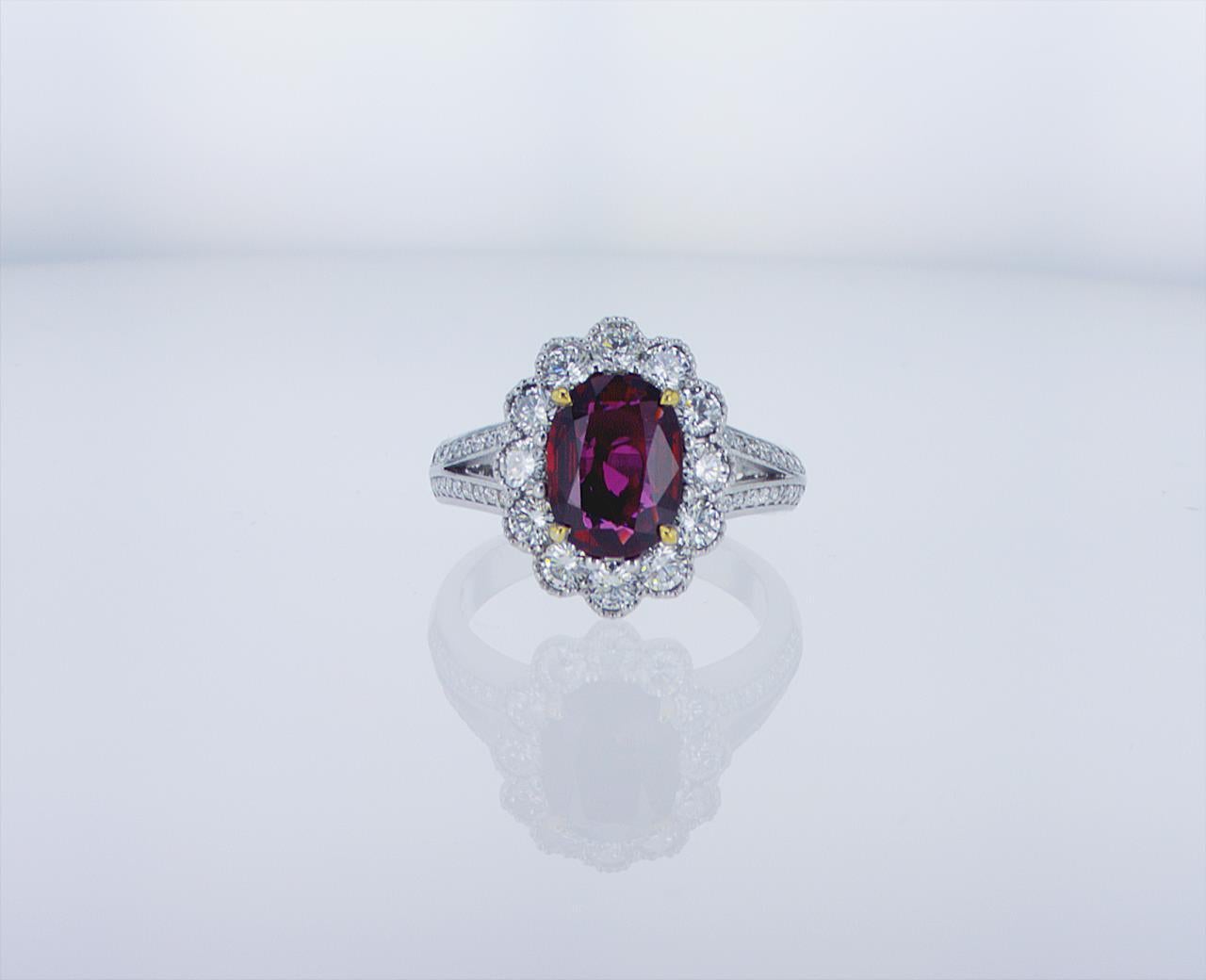 Oval Thai Ruby, 2.03 Carat. 1.08 Carats total weight of round brilliant diamonds G/H color, VS clarity. 18k White Gold with Palladium mounting, and 18k Yellow Gold center prongs.