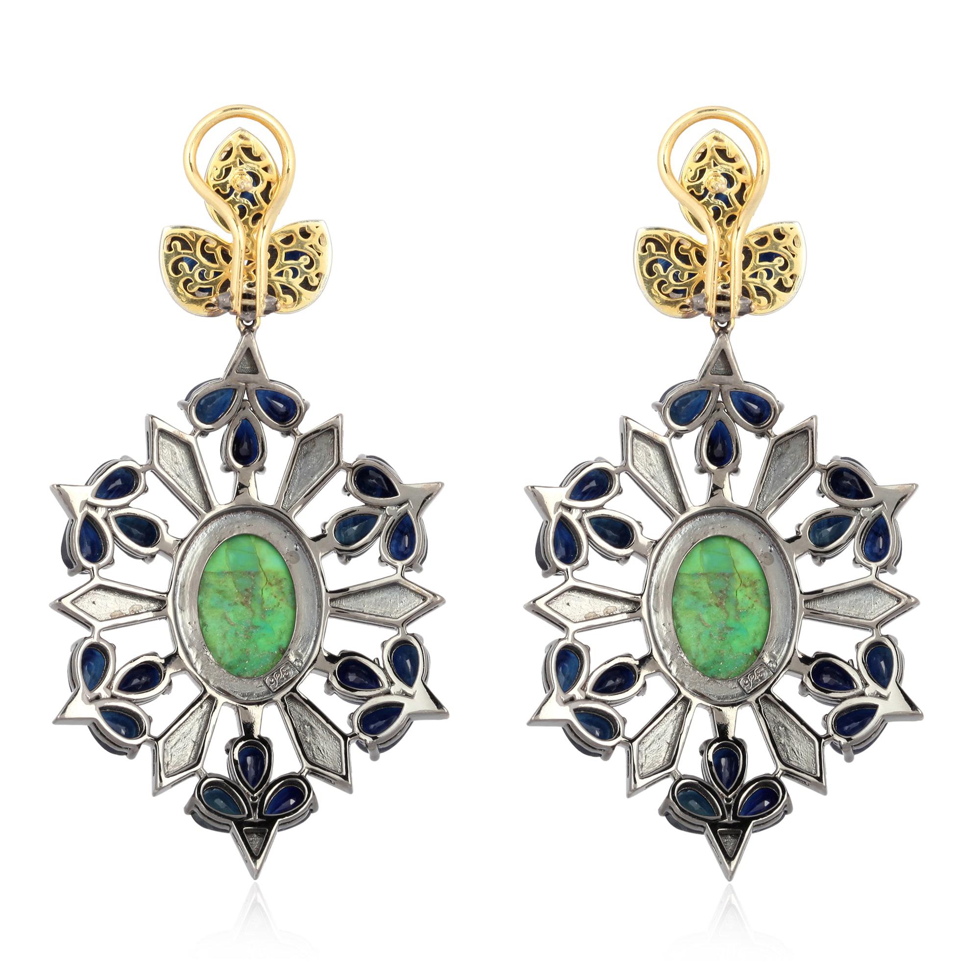 Cast in 18-karat gold & sterling silver, these stunning drop earrings are set with 20.33 carats blue sapphire, 6.3 carats turquoise and 2.67 carats of sparkling diamonds. 

FOLLOW  MEGHNA JEWELS storefront to view the latest collection & exclusive