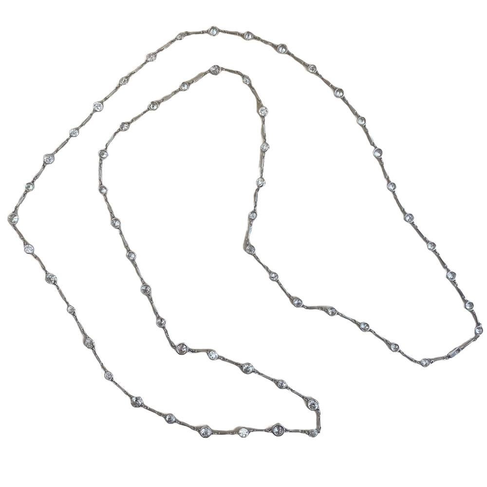 This exquisite long necklace is masterfully crafted in platinum, showcasing a total of approx 20.30-carats of dazzling old European-cut diamonds. Each diamond is meticulously bezel-set, enhancing its brilliance while maintaining a refined and