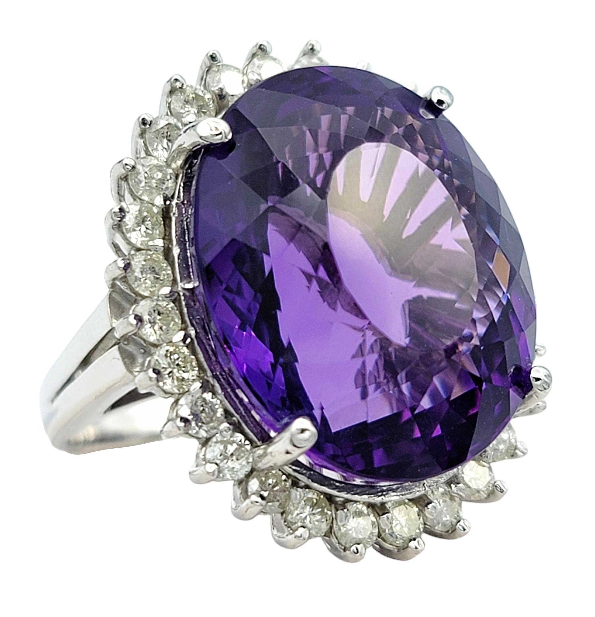 Ring Size: 7 

This breathtaking 20.35 carat oval amethyst cocktail ring is crafted  in luxurious 14 karat white gold. This stunning piece is a true showstopper, designed to captivate and enchant with its extraordinary beauty and elegance. The
