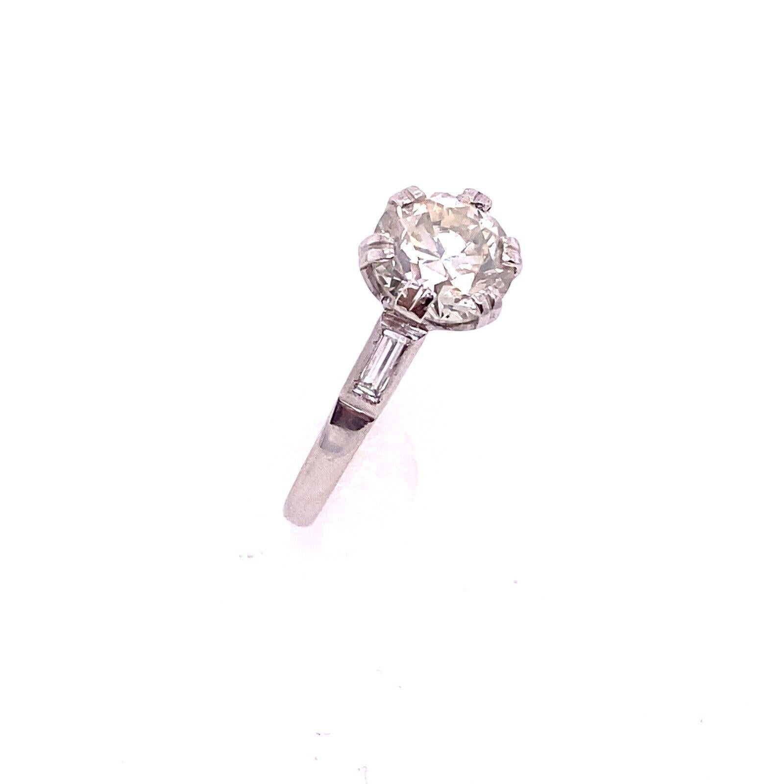 This Diamond is absolutely gorgeous. It is a 2.03ct round brilliant cut Diamond with an L1 clarity and an I1 colour. The Diamond is set in a beautiful 18ct White Gold setting with one baguettes on each shoulder. This Diamond is absolutely perfect