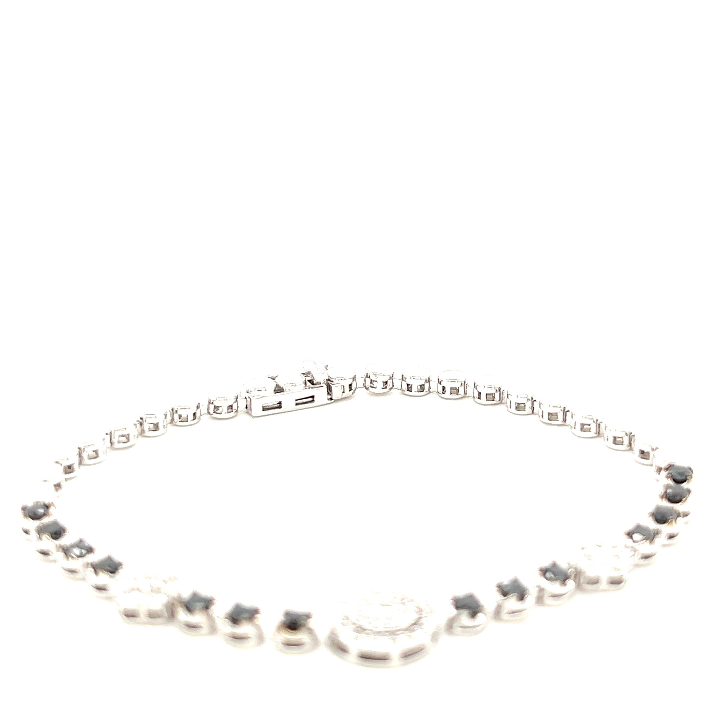 This bracelet has Natural Round Cut Black Diamonds that weigh 1.11 carats and Natural Round Cut Diamonds that weigh 0.93 carats, (Clarity: SI, Color: F)

It is set in 14 Karat White Gold and has an approximate gold gram of 9.0 grams.

The bracelet