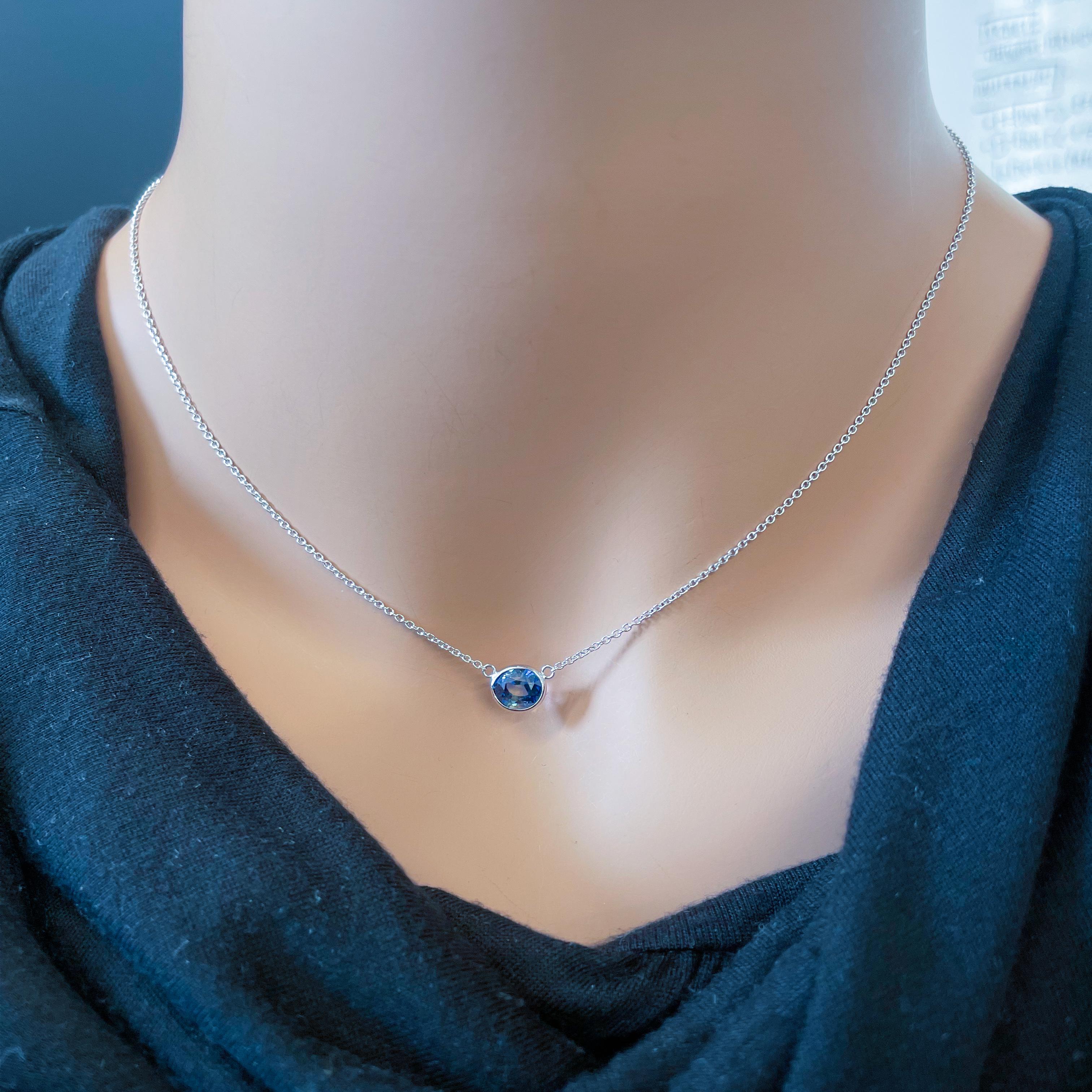 This necklace features an oval-cut blue sapphire with a weight of 2.04 carats, set in 14k white gold (WG). Blue sapphires are prized for their stunning deep blue color, and the oval cut is a classic and timeless choice for gemstones. Oval-cut