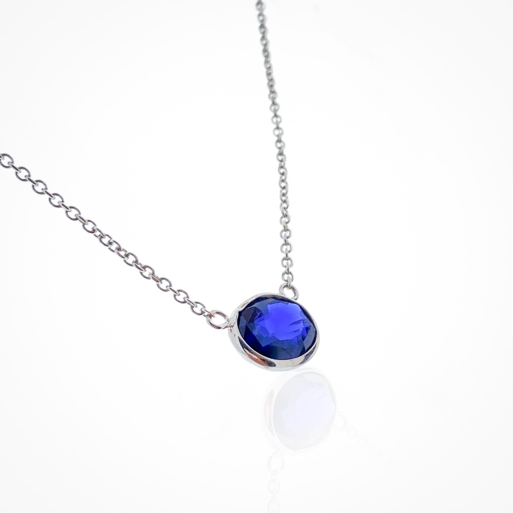This necklace features an oval-cut blue sapphire with a weight of 2.04 carats, set in 14k white gold (WG). As previously mentioned, blue sapphires are renowned for their rich, deep blue color, and the oval cut is a timeless and elegant choice for