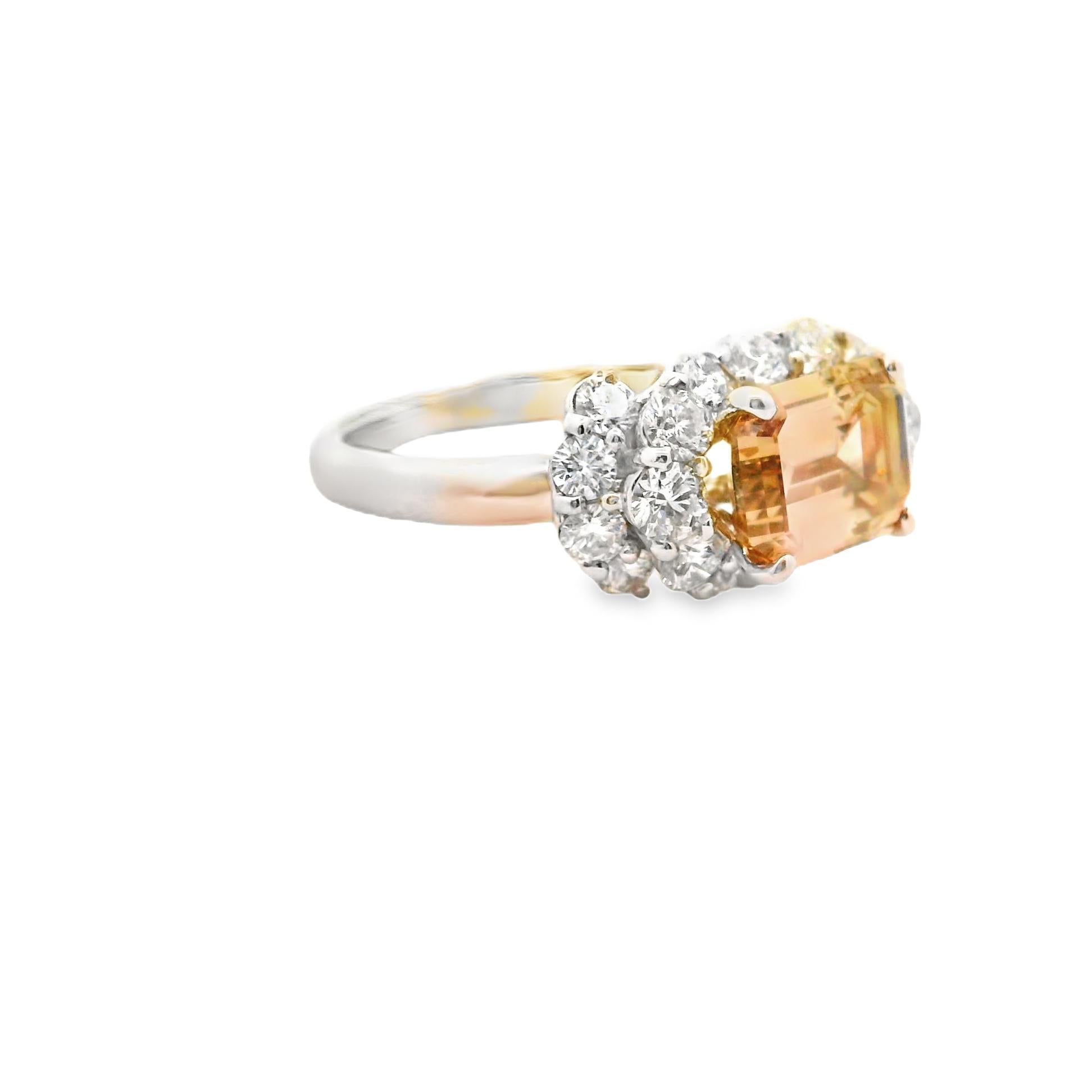 A chic and elegant platinum ring featuring a 2.04 carat emerald-cut diamond with a bright fancy-brown color. The emerald-cut diamond has a lighter almost golden color with excellent brilliance and light return. It is complemented by 1.07 carats of