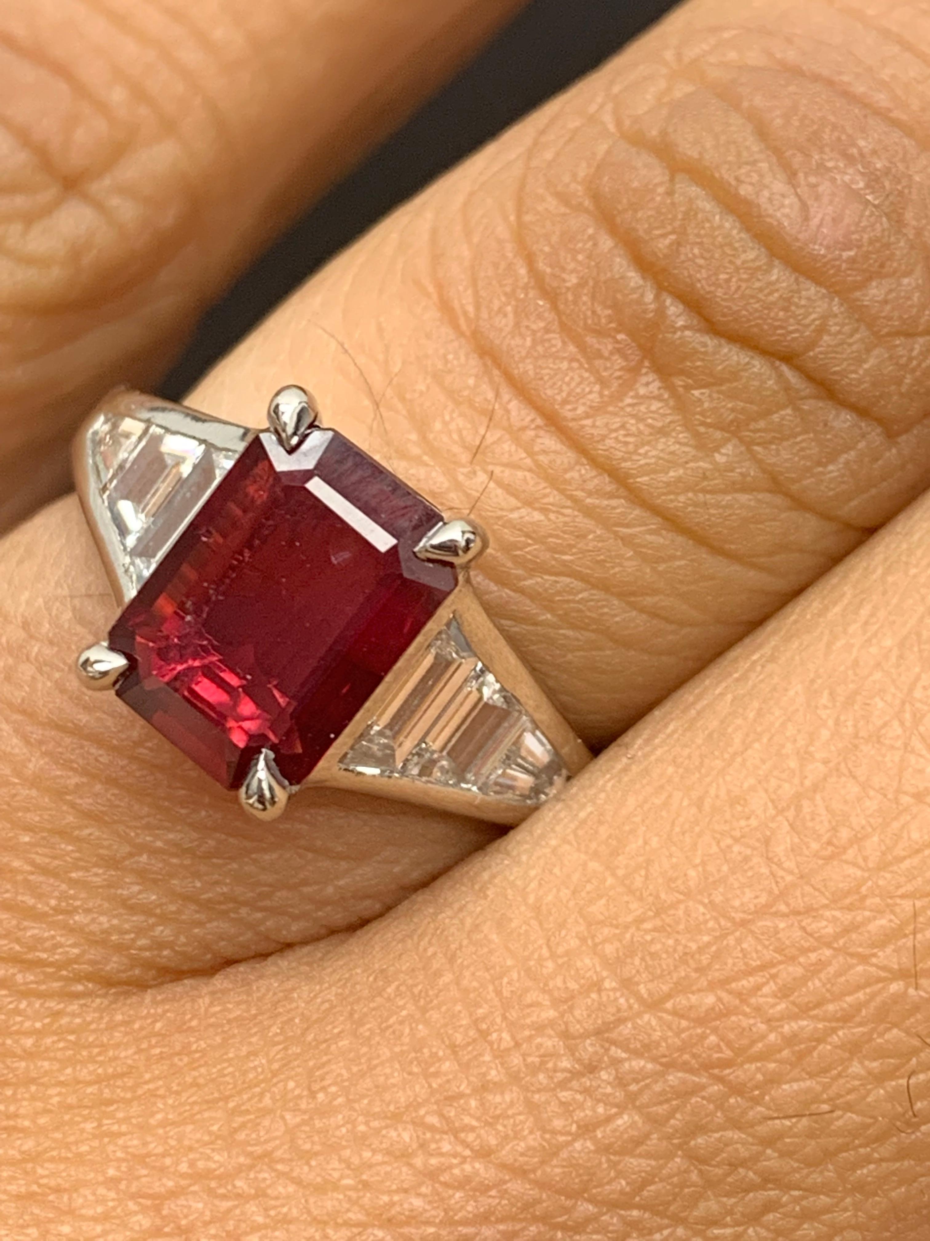 A stunning well-crafted engagement ring showcasing a 2.04-carat  emerald-cut Ruby. Flanking the center diamond are perfectly matched graduating step-cut diamonds, channel set in a polished platinum mounting. 6 Accent diamonds weigh 0.73 carats