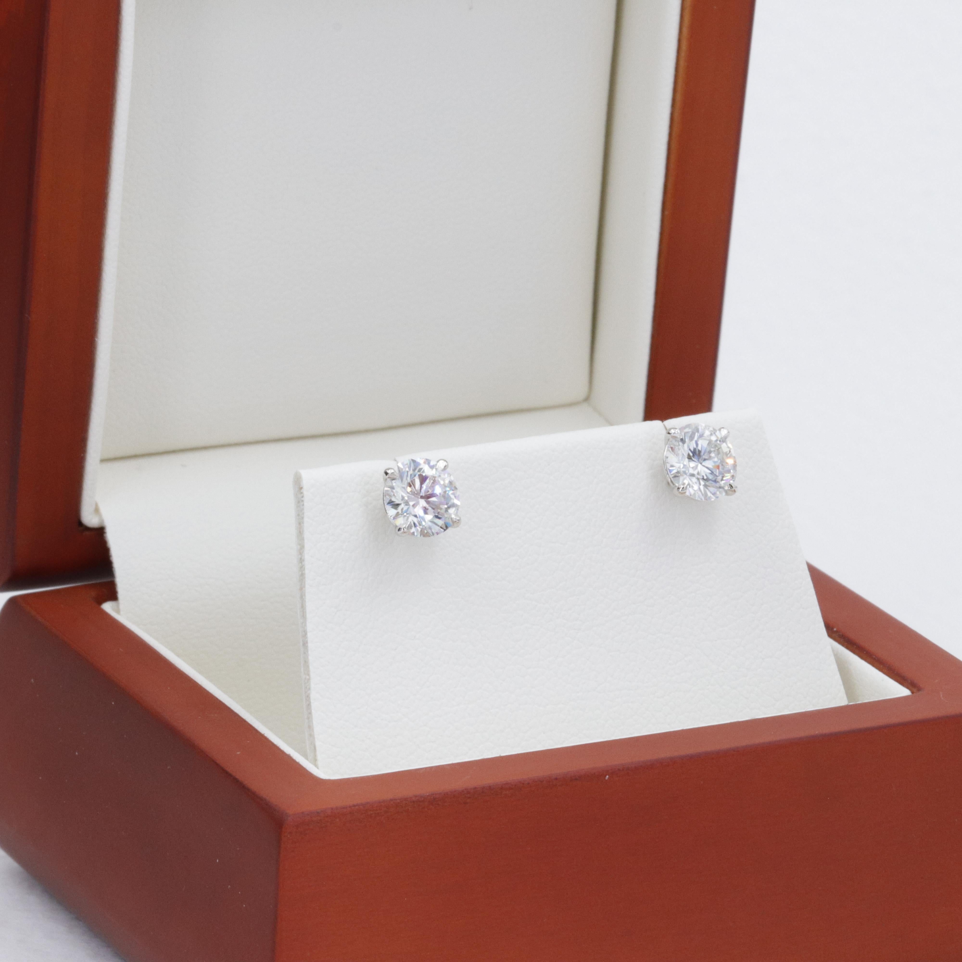 A fine pair of perfectly matched natural diamonds weighing 2.04 carats, with accompanying reports from the Gemological Institute of America (GIA) grading both of the diamonds as a bright white I in color with an exceptionally clean VS1 in clarity.