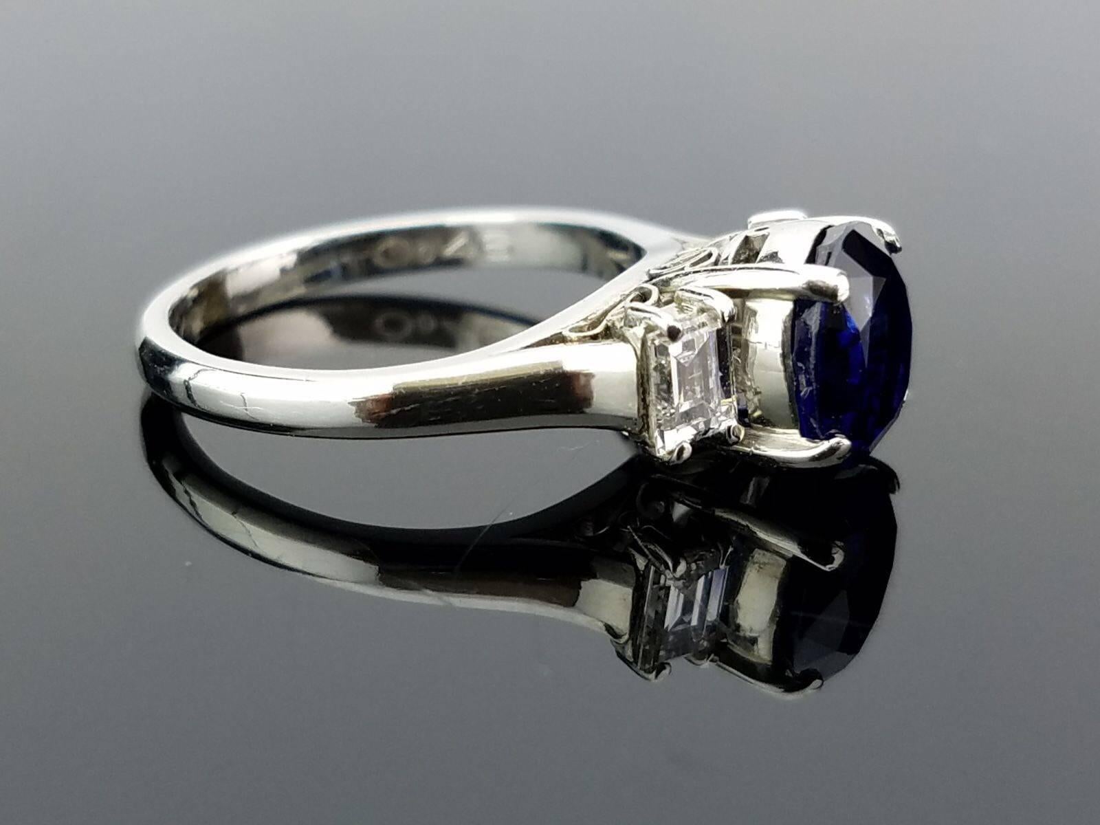An art-deco looking 2.04 carat Sapphire ring, set with 2 white diamond side stones in Platinum.

Stone Details: 
Stone: Sapphire
Carat Weight: 2.04 Carats

Diamond Details: 
Total Carat Weight: 0.46 carat
Quality: VS , H/I

Platinum: 3.97