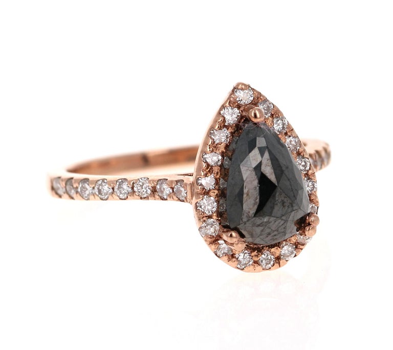 Gorgeous Black Diamond ring that can transform into an Engagement ring!! 

There is a 1.62 Carat Pear Cut Black Diamond in the center on the ring which is surrounded by a Halo of  34 White Round Cut Diamonds that weigh 0.42 Carats (Clarity: SI,