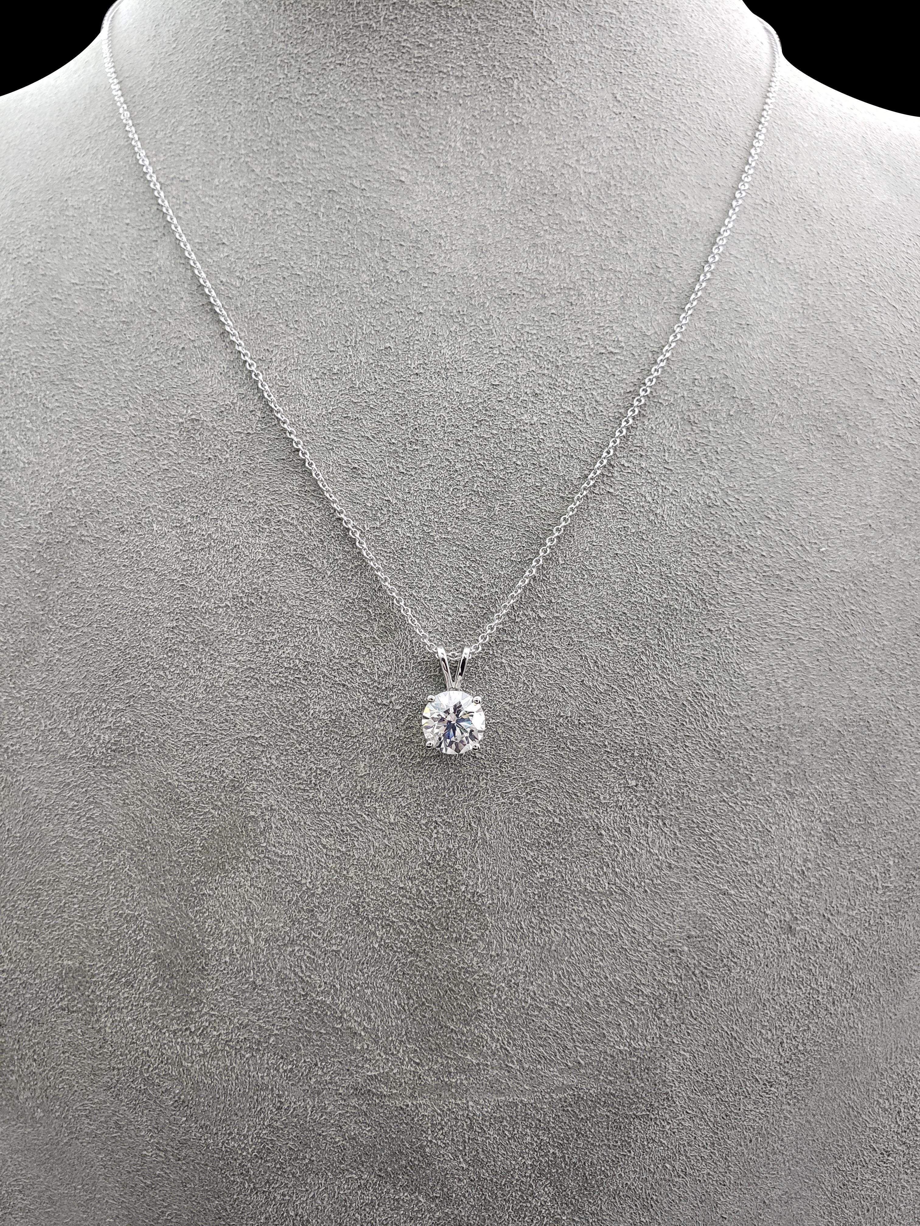 A simple and timeless piece of jewelry that carries a lot of sparkle. Features a 2.04 carat round brilliant diamond set in an elegant 14 karat white gold basket. Suspends on a V-shaped bale on an 18 inch white gold chain (adjustable upon