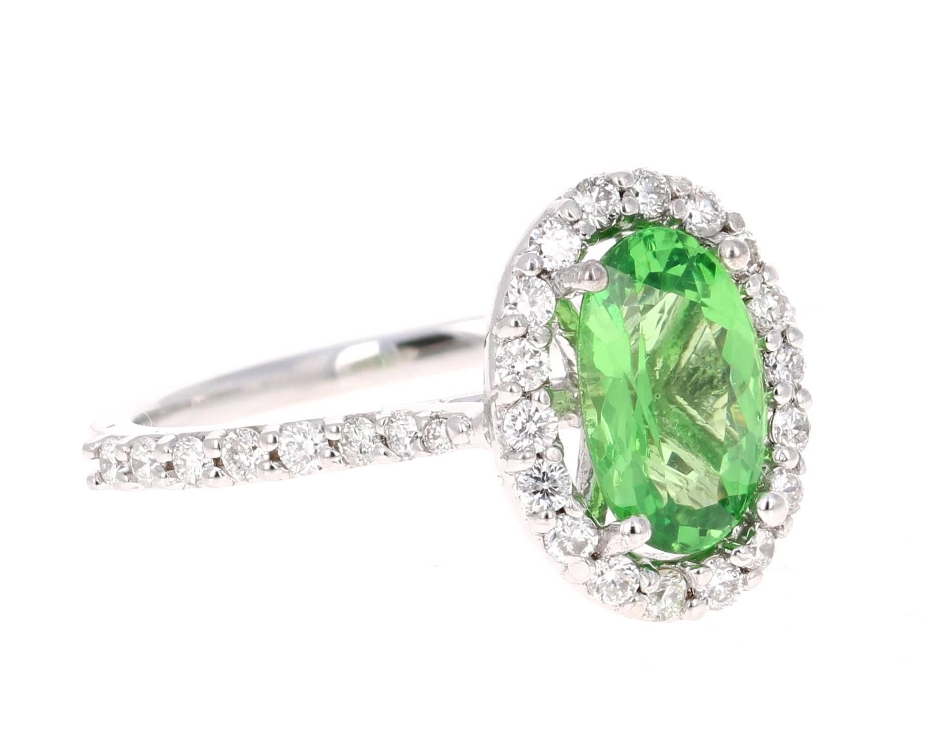 Elegant and simple halo setting that can compliment anyone!  This ring can easily transform into a promise ring for the woman who wants to dip into something new and fresh. It has an Oval Cut Tsavorite which weighs 1.58 carats and is surrounded by a