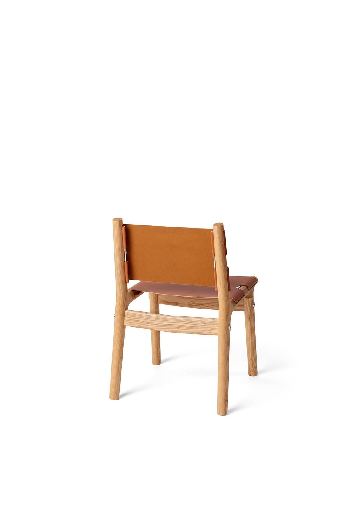 The 204 side chair has a hand-formed frame composed of North American ash with mirror-polished aluminium fittings. Its rugged harness leather slings relax to a gentle sweep, and age to a gorgeous patina with use. 

Measures: H 29.5