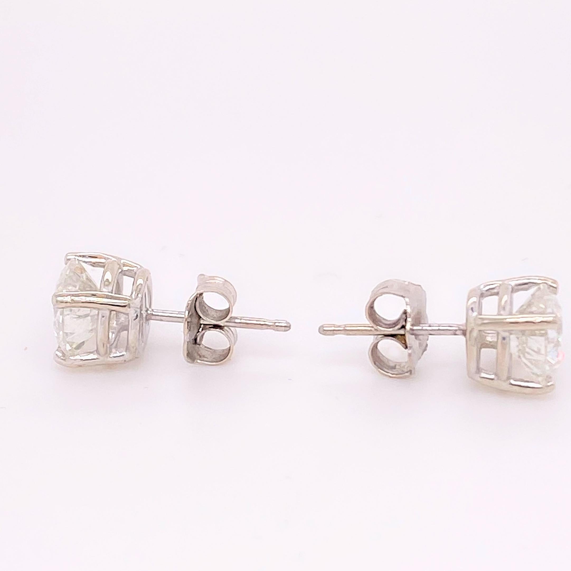 Diamond Stud Earrings
Style:  Basket Settings with Friction Backs
Metal:  14K White Gold
TCW:  2.04 Carats Total
Diamonds:  2 Round Brilliant Cut Natural Diamonds
Color & Clarity:  I color,  I1 clarity
Hallmark: 14K
Includes:  Certified Appraisal,