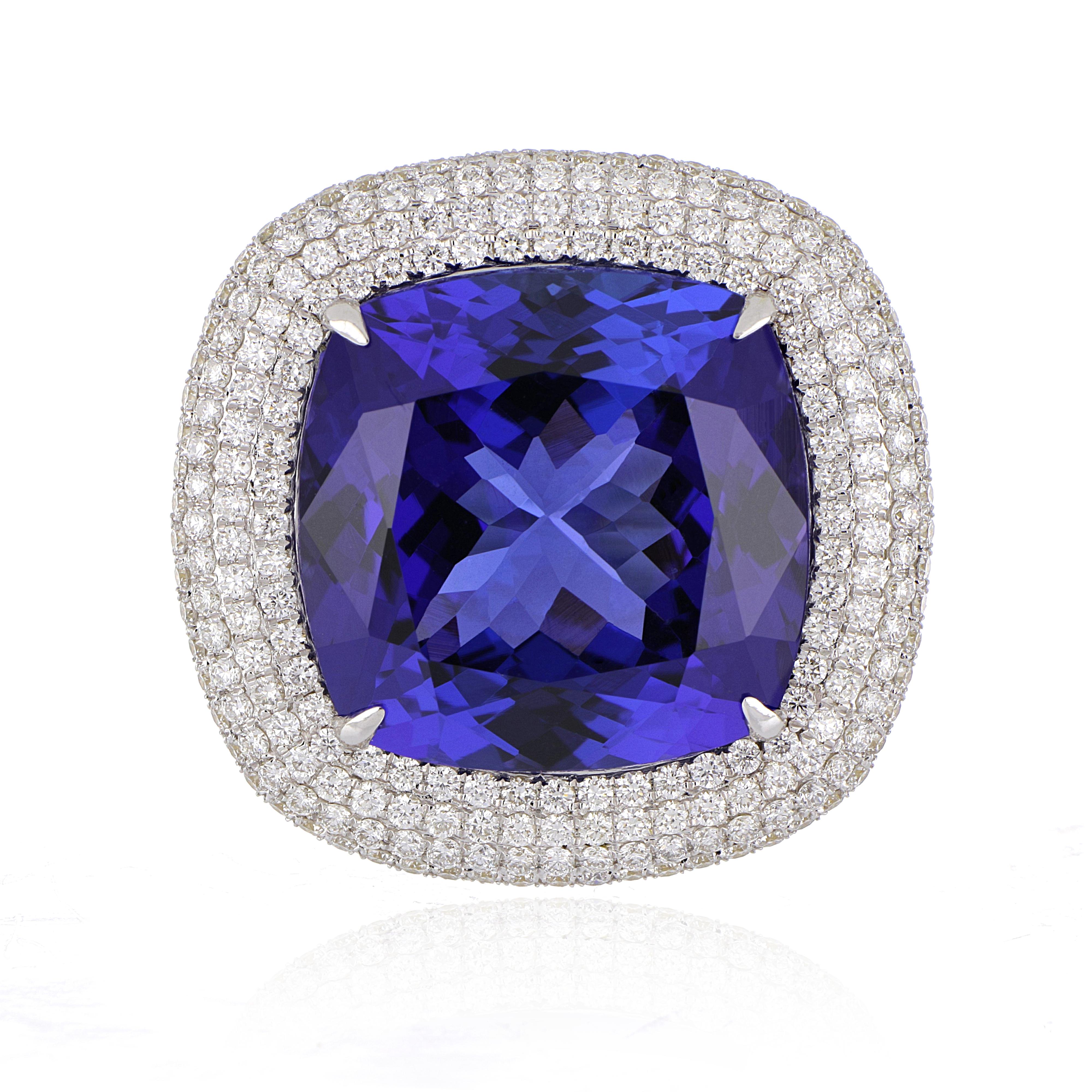 Elegant and exquisitely detailed 18K Ring, centre set with 20.41 Ct Tanzanite, surrounded by and enhanced on shank with micro pave Diamonds, weighing approx. 1.66 total carat weight. Beautifully Hand crafted in 18 Karat white Gold.

Stone Size: