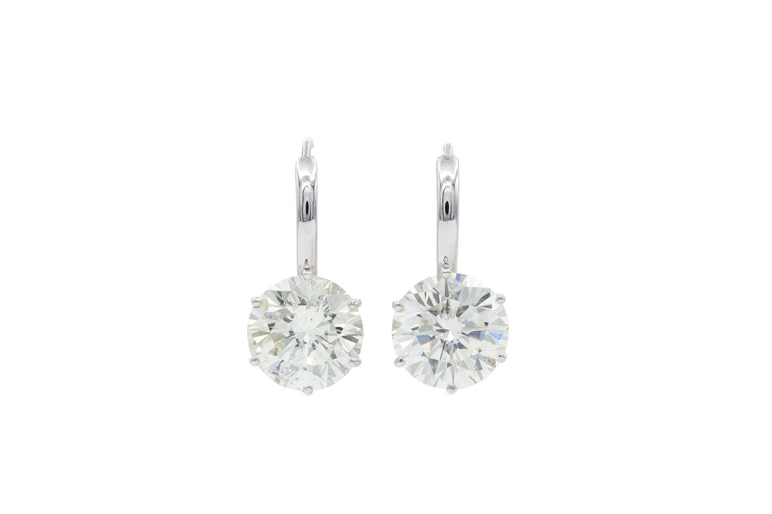 We are  pleased to present these EGL Certified Round Brilliant Cut Diamond & Platinum French Hook Solitaire Earrings. These truly stunning earrings are sure to make a statement! The two gorgeous natural round brilliant cut diamonds were just