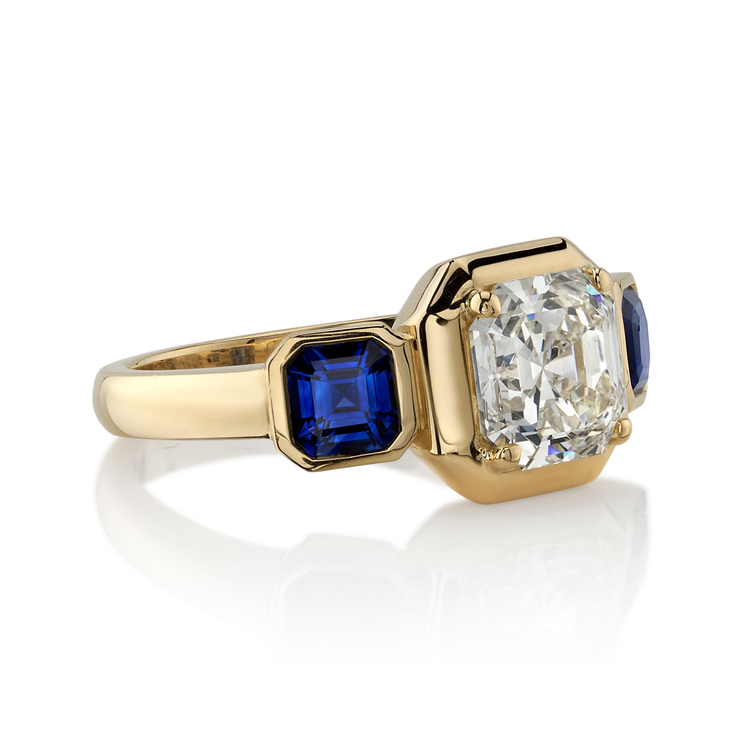 2.05ctw N/VVS2 GIA certified Asscher cut diamond flanked by 1.09ctw blue sapphires set in a handcrafted 18K yellow gold mounting.

Ring is currently a size 6 and can be sized to fit.