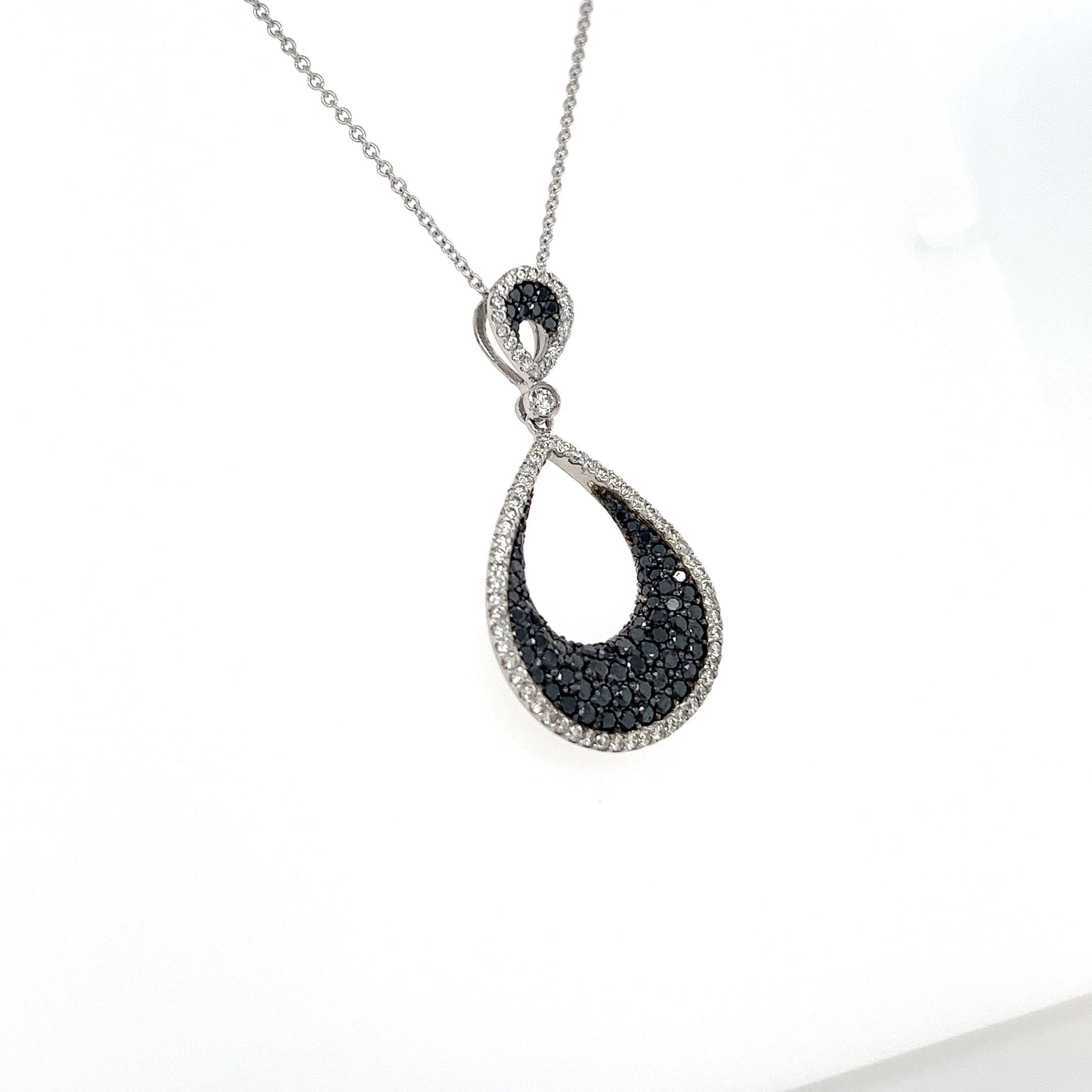 This necklace has Natural Black Diamonds that weigh 1.30 carats and Natural Round Cut Diamonds that weigh 0.75 carats. 
(Clarity: VS, Color: F) The total carat weight of the necklace is 2.05 carats.

The necklace is made in 14 Karat White Gold and