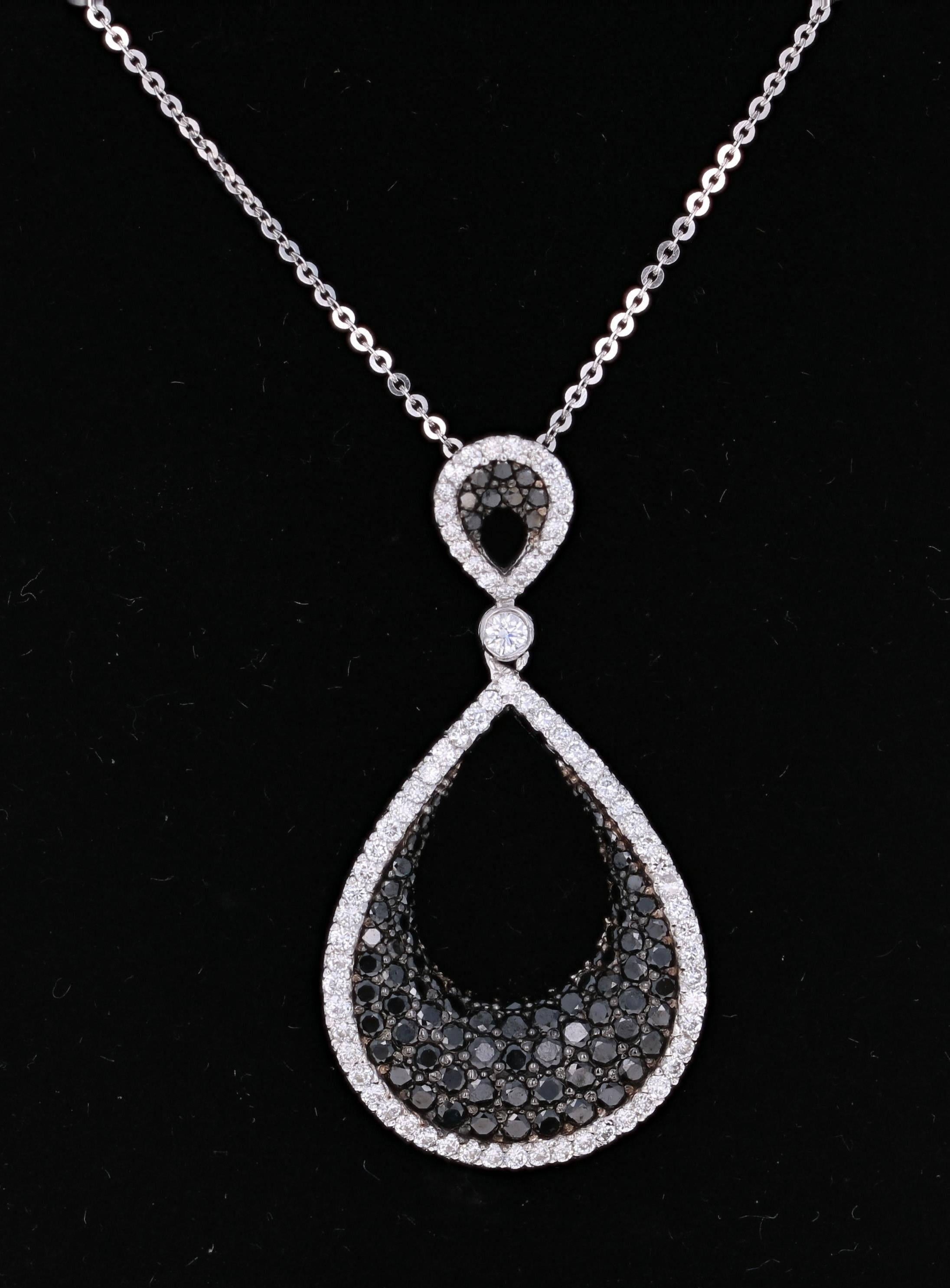 Beautiful 2.05 Carat Black Diamond and White Diamond Pendant in 14K White Gold.  This intricate design has 76 Round Cut Diamonds that weigh 0.75 carats (Clarity: VS2, Color: F) and 90 Black Diamonds that weigh 1.30 carats.  The Black Diamond is a