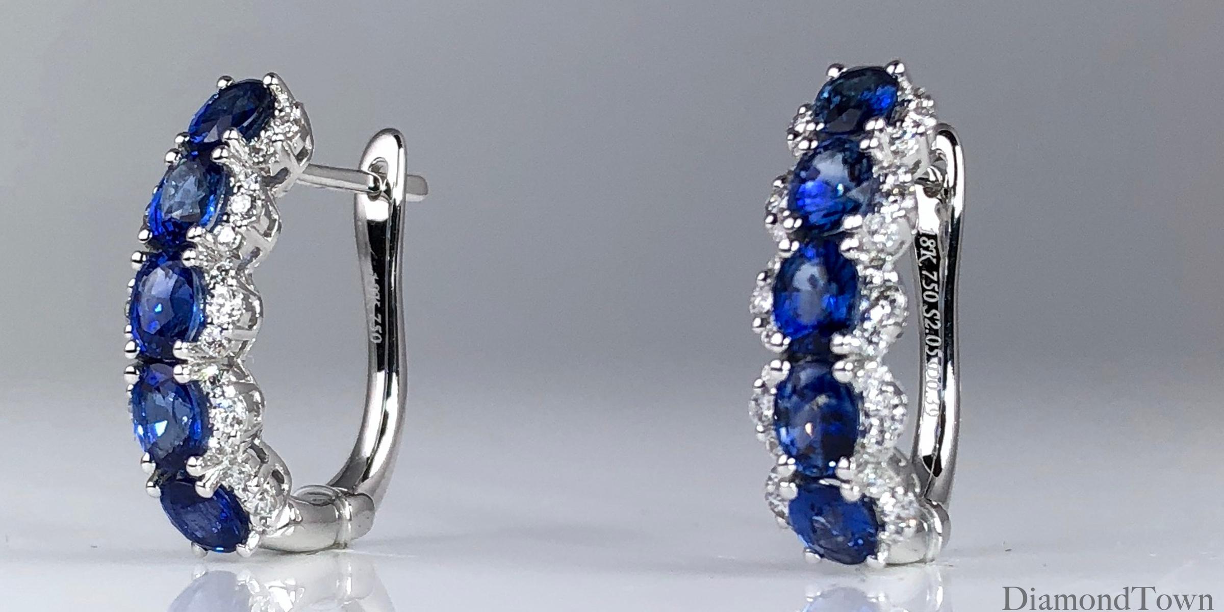 These lovely hoop earrings feature 5 oval cut blue sapphires (total weight 2.05 carats), wrapped among round diamonds (total diamond weight 0.39 carats). The earrings close securely by lever-back. Set in 18k White Gold.

Many of our items have