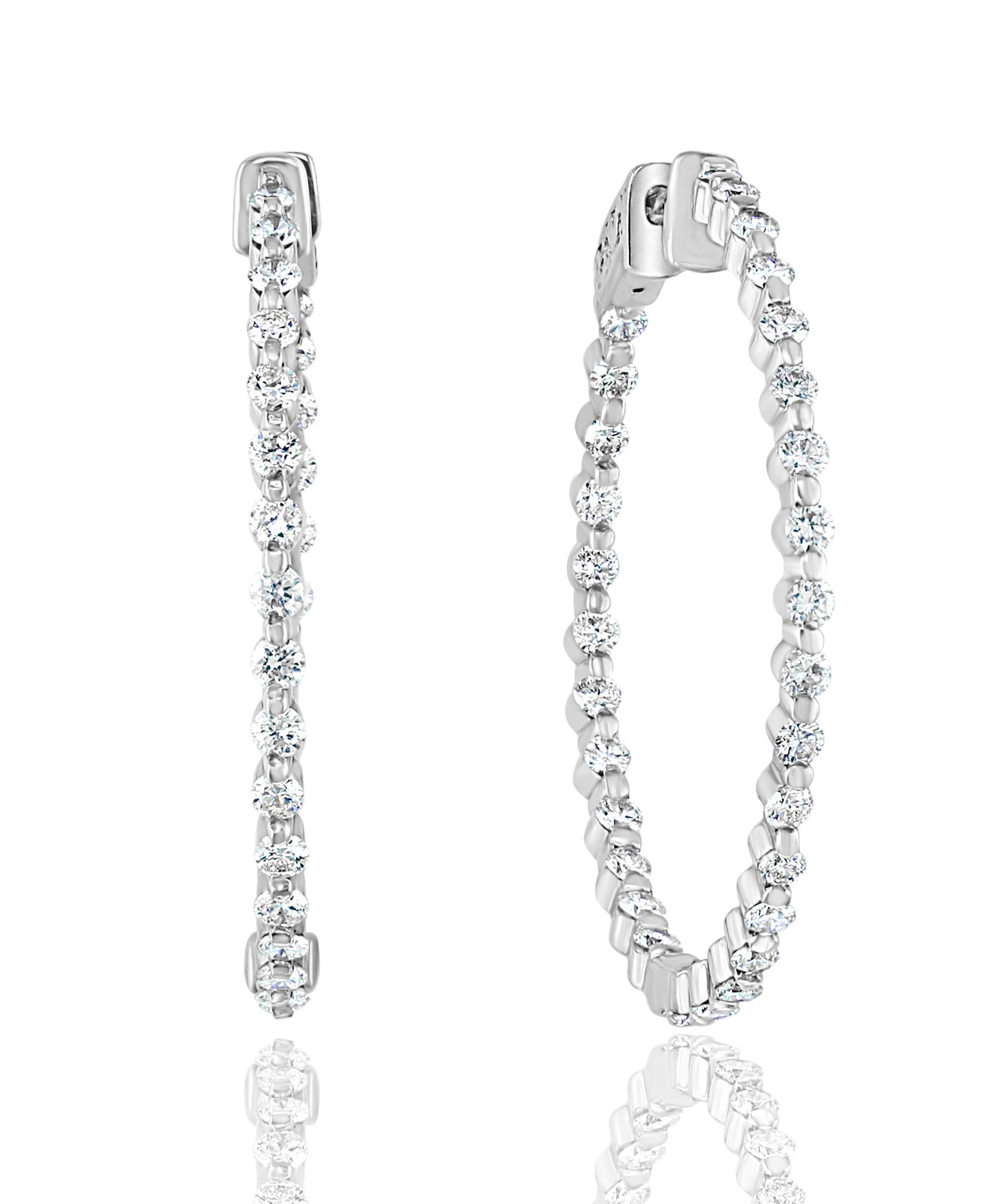 Gorgeous and classic diamond hoop earrings. Features dazzling brilliant cut round diamonds set in shared prongs to maximize the brilliance of the diamonds. The total weight of the 52 diamonds is 2.05 carats. Made in 14k white gold. 