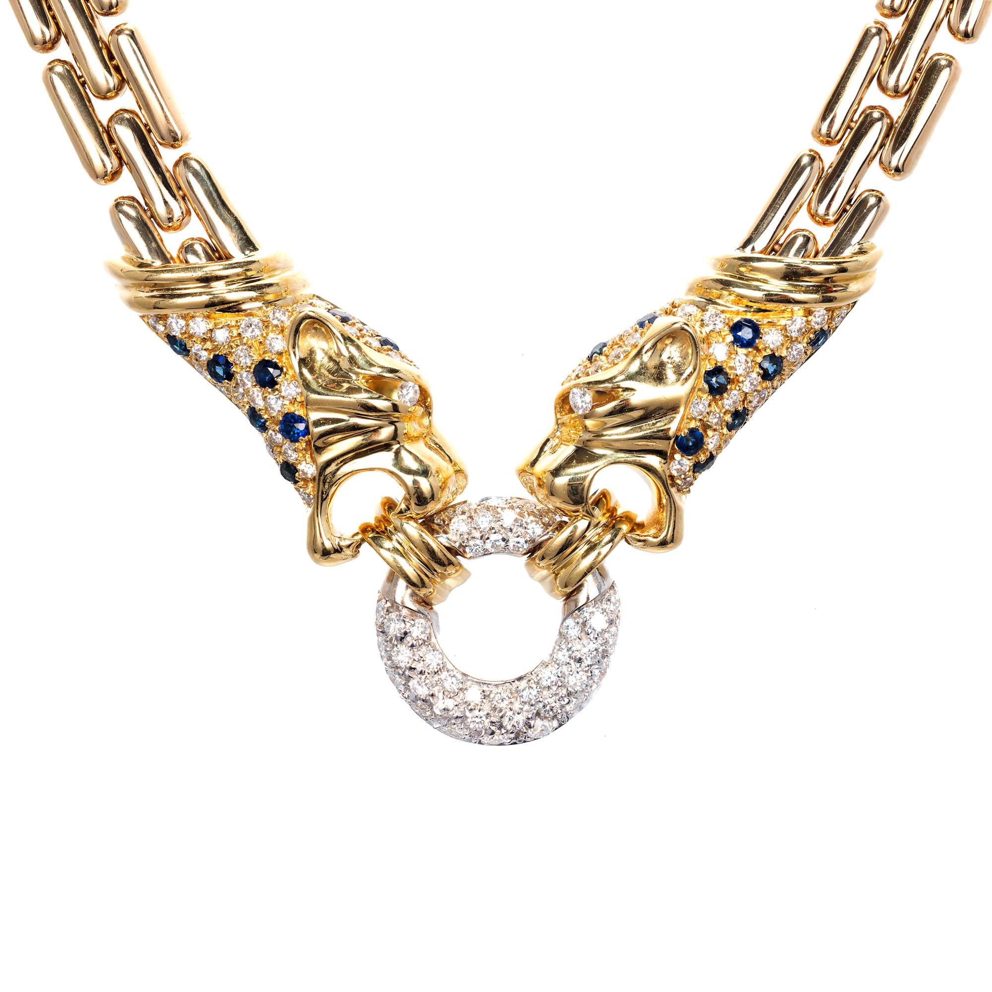Three row panther necklace in 18k yellow gold with two diamond sapphire panther hands and a diamond circle in the middle. Circa 1990

74 round brilliant cut G-H VS diamonds Approximate .95 carats 
17 Blue Sapphires .50 carats
42 round brilliant cut