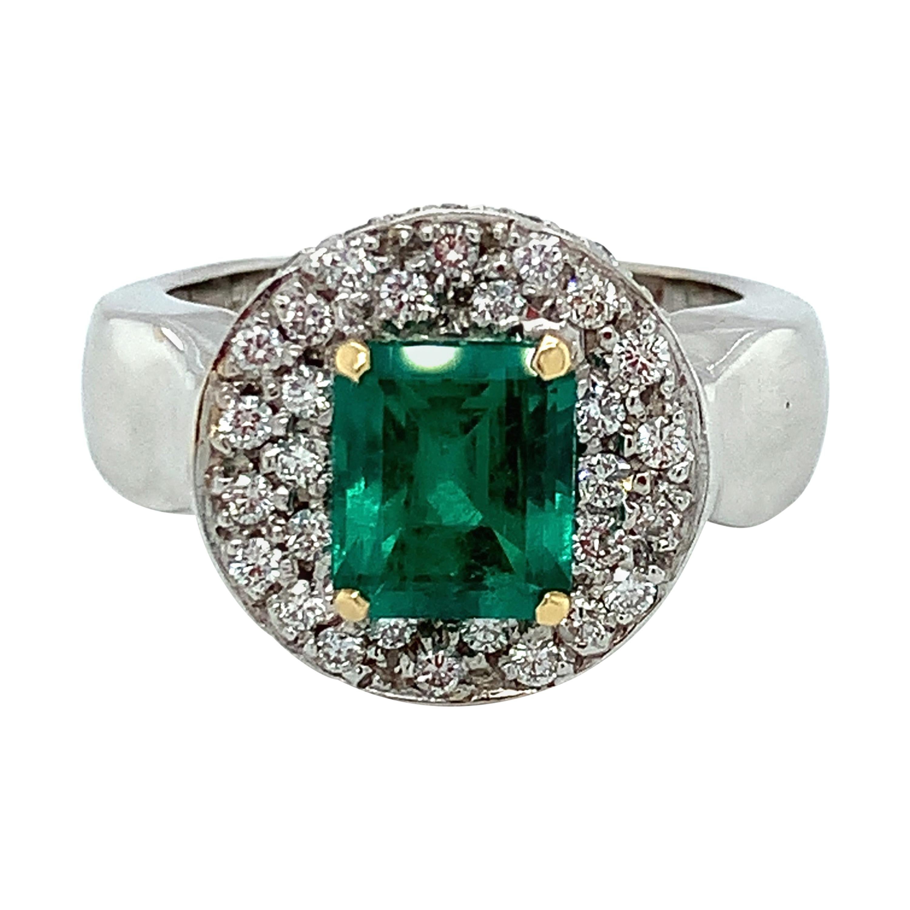 This unusual cocktail ring ring features a beautiful 2.05 carat emerald-cut emerald in an elegant yet fun Art Deco/Retro design! The emerald is stunning, with gorgeous color that is showcased beautifully against the sparkling backdrop of pave-set