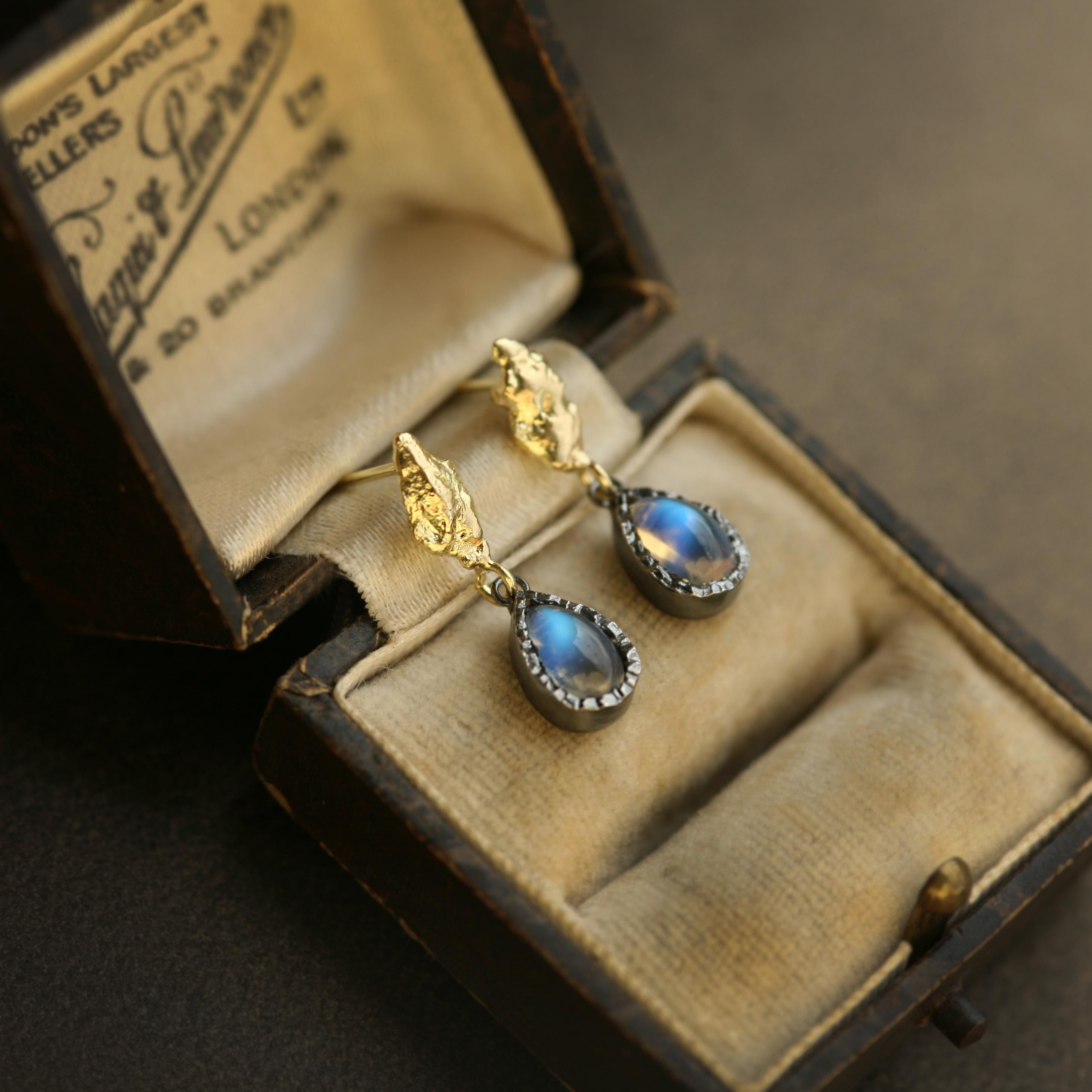 2.05 Carat Rainbow Moonstone Pear 18k Gold and Silver Statement Drop Earrings.

Lava Iridesce Earrings in 18k gold evoke the molten origins of Earth, within which geological pressure and time fuse matter into luminous form. Each sculptural curve