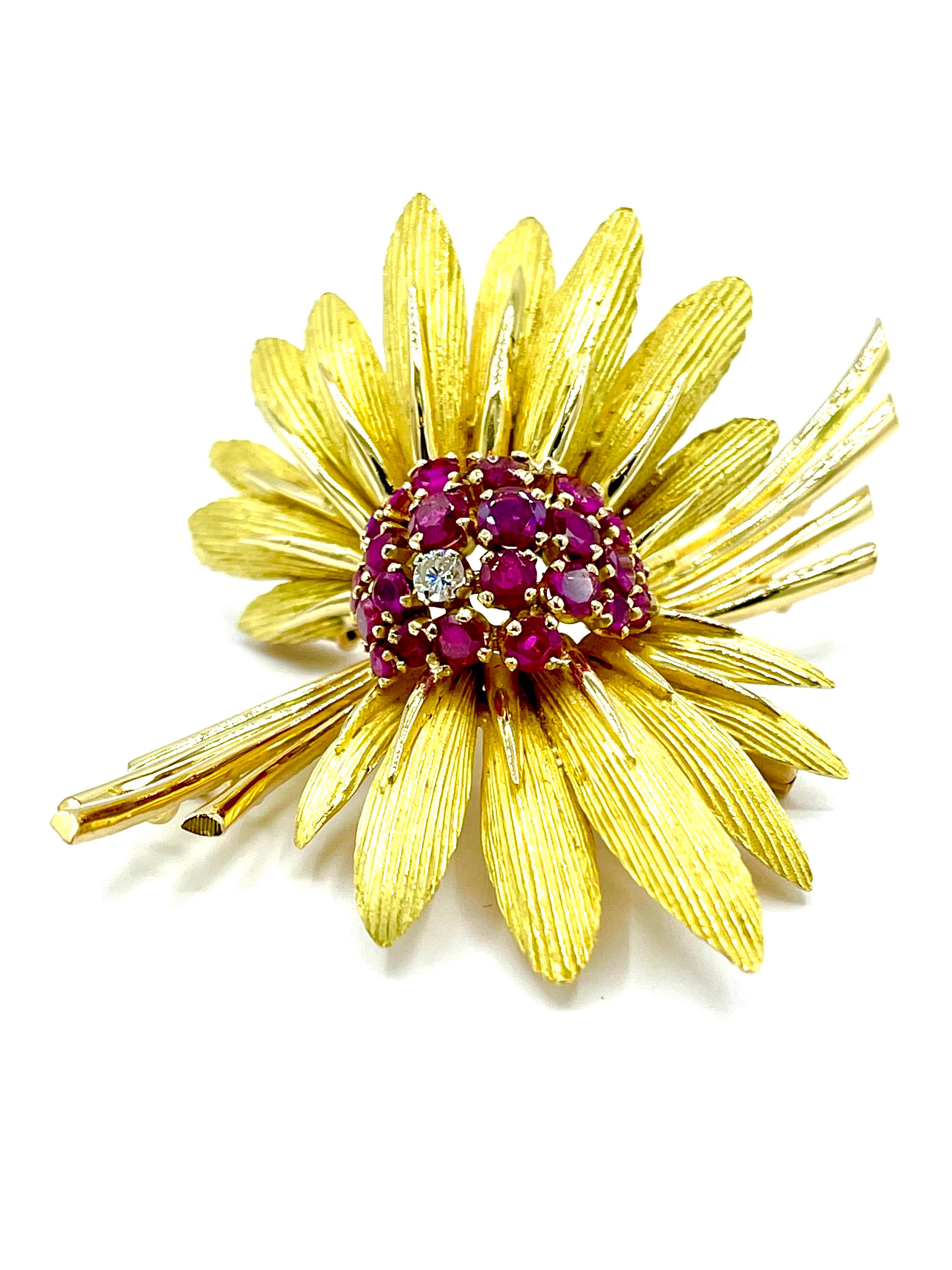 Such an incredibly detailed design feathered brooch.  The domed center contains 24 round faceted Rubies with one round brilliant cut Diamond.  The feathers have a beautiful brushed gold finish with polished stems in 18k yellow gold.  There is a