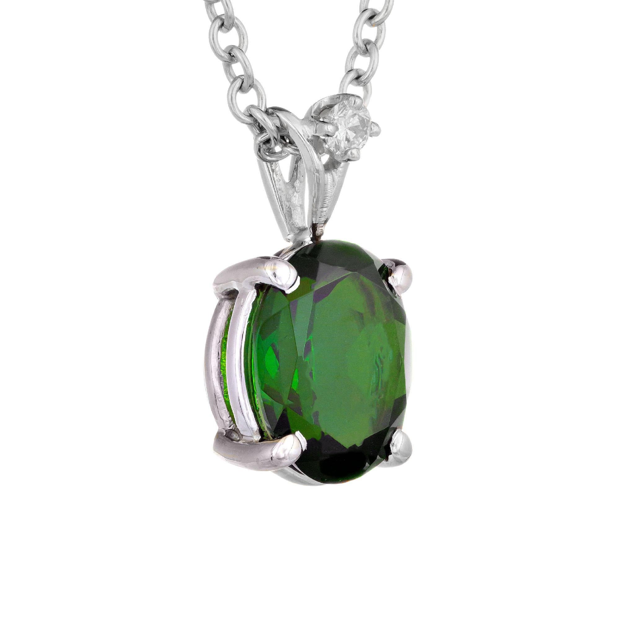 Green tourmaline diamond pendant necklace. Oval center stone with 1 round accent diamond in 14k white gold. 19 inch chain.  

1 oval green tourmaline, SI approx. 2.05ct
1 brilliant round cut diamond, G SI approx. .4ct
14k white gold 
Stamped: