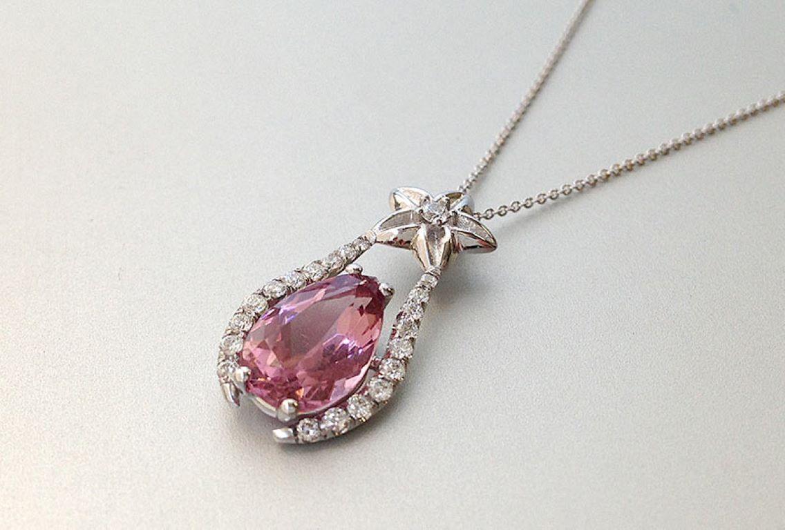 Looking for a present for your adorable niece? This delicate baby pink Tourmaline could be just the right choice for her youthful spirit. Handcrafted in 14K White Gold it is studded with sparkling diamonds. The pendant has a star motif that will