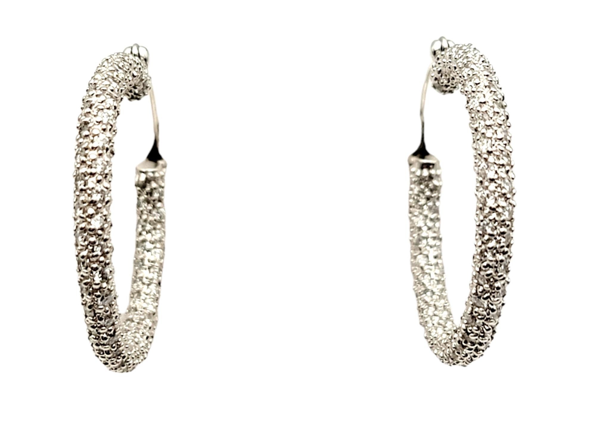 If you are looking for dazzling sparkle from every angle, these stunning pave diamond hoop earrings will not disappoint! Arranged in a unique inside/outside setting, the diamonds are positioned to catch the light from different angles, making your
