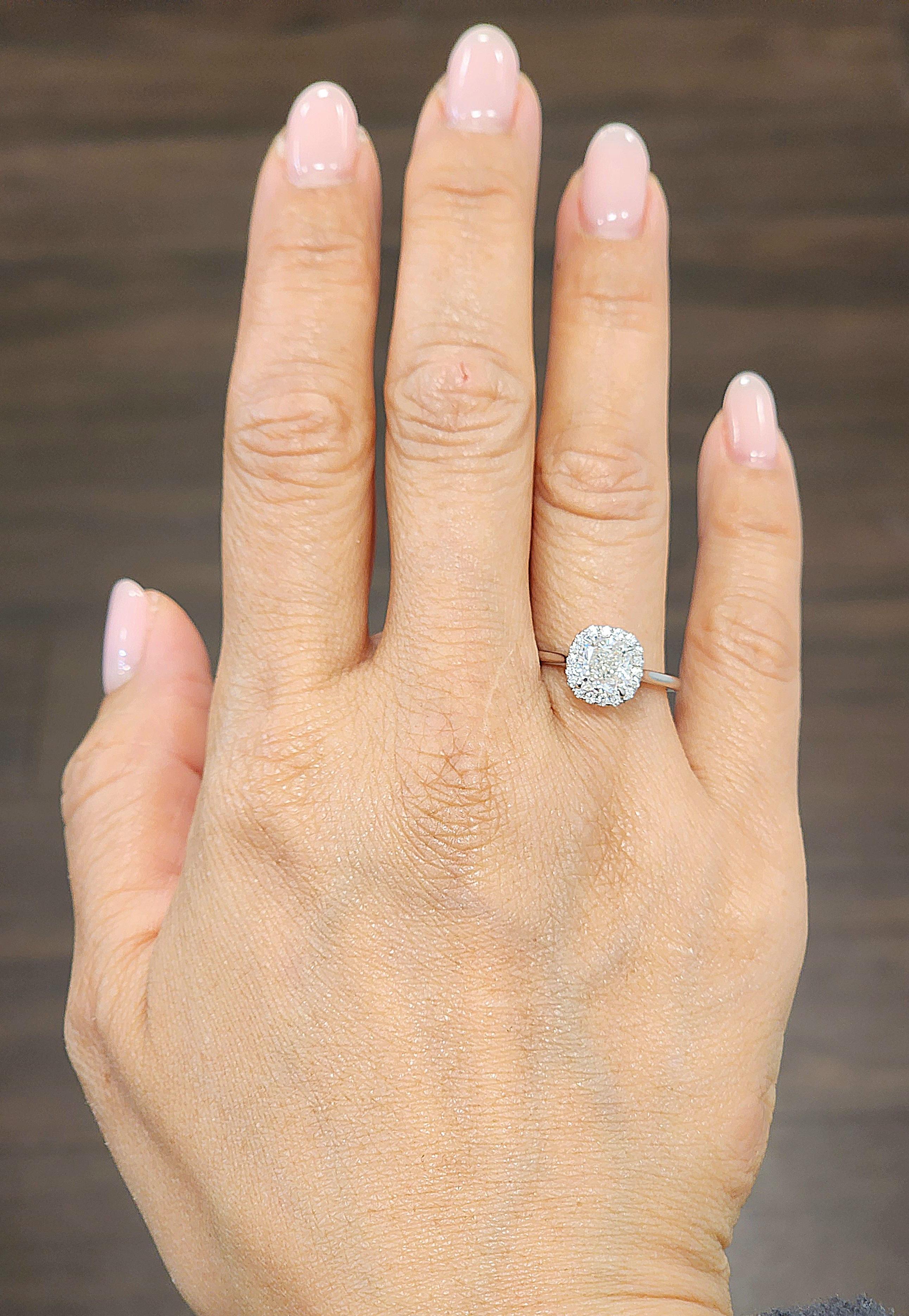This elegant engagement ring features a GIA-certified 1.75-carat cushion-cut diamond, exuding a brilliant white hue. Surrounded by round-cut diamonds totaling 0.3 carats, each stone is G/H in color and VS1 in clarity. Crafted in 14k white gold, this